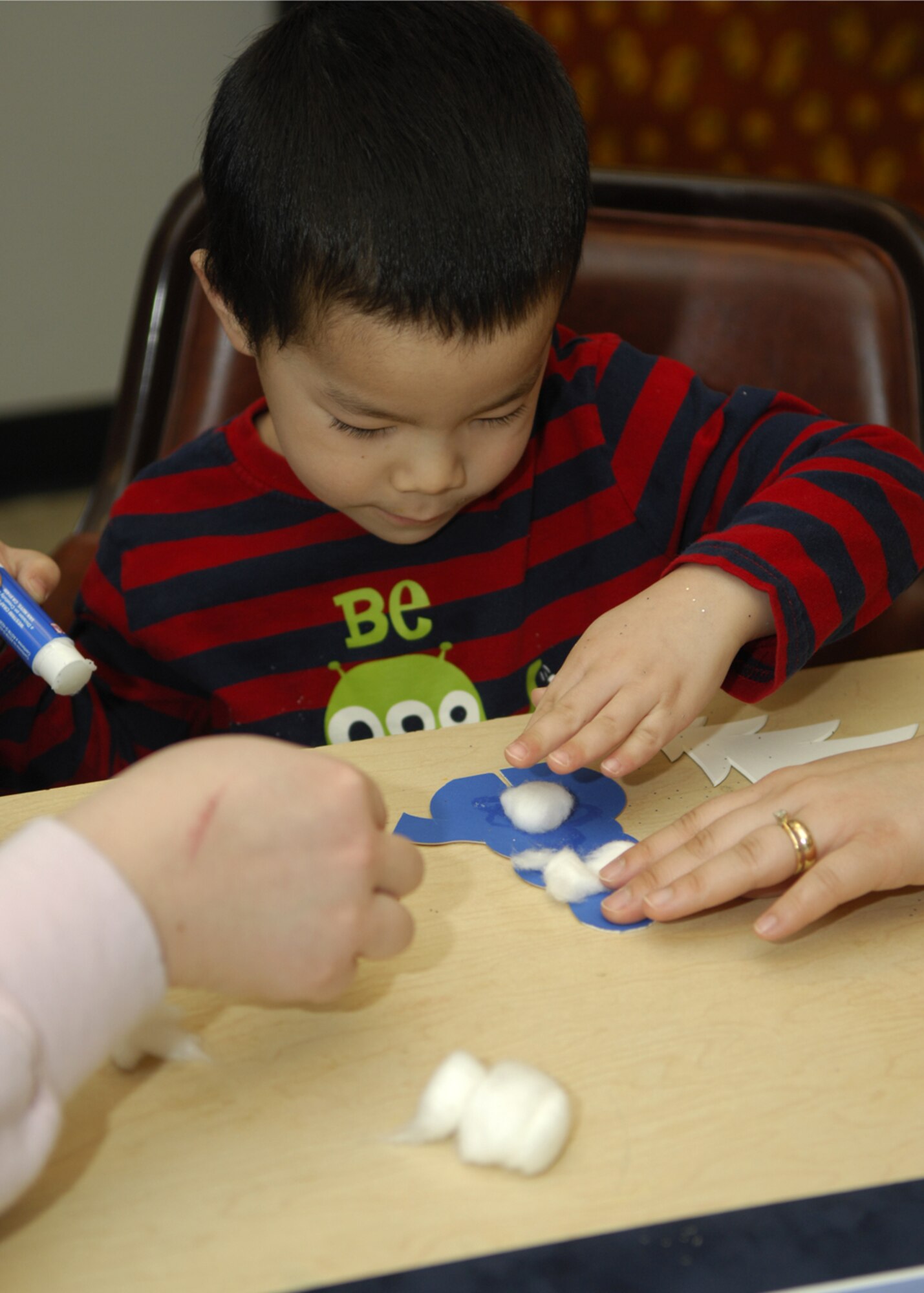 MINOT AIR FORCE BASE, N.D. -- Roman Slajchert, son of Staff Sgt. Jason Slajchert, 5th Medical Operations Squadron medical technician, places cotton balls onto a snowman cutout during the Creative Kids class Feb. 18. The Arts and Crafts Center holds the class every third Thursday of every month. The center provides this class so the children of Team Minot may have a fun, hands-on activity they may enjoy with their parents. (U.S. Air Force photo by Airman 1st Class Ashley N. Avecilla)