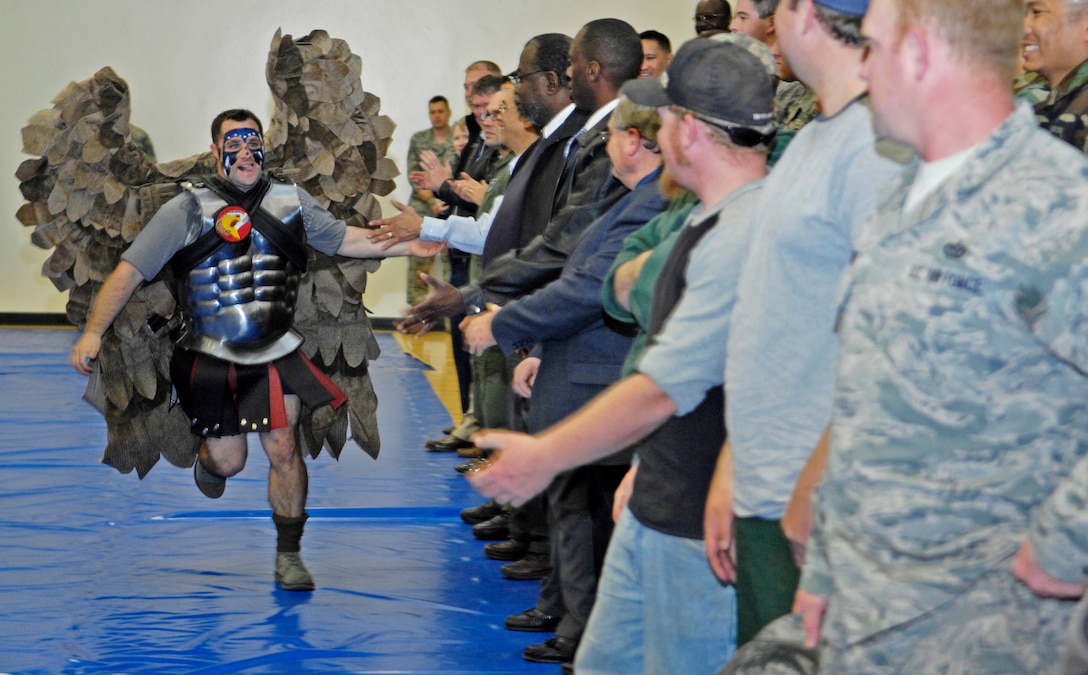 VANDENBERG AIR FORCE BASE, Calif.  --  The new and improved Hawk Man gets the crowd pumped and on their feet by running around the gym giving high-fives during the 30th Space Wing commander's call here Monday, Feb. 22, 2010. Hawk Man led the way for the entrance of Vandenberg's 2009 Guardian Challenge teams. (U.S. Air Force photo/Airman 1st Class Andrew Lee)