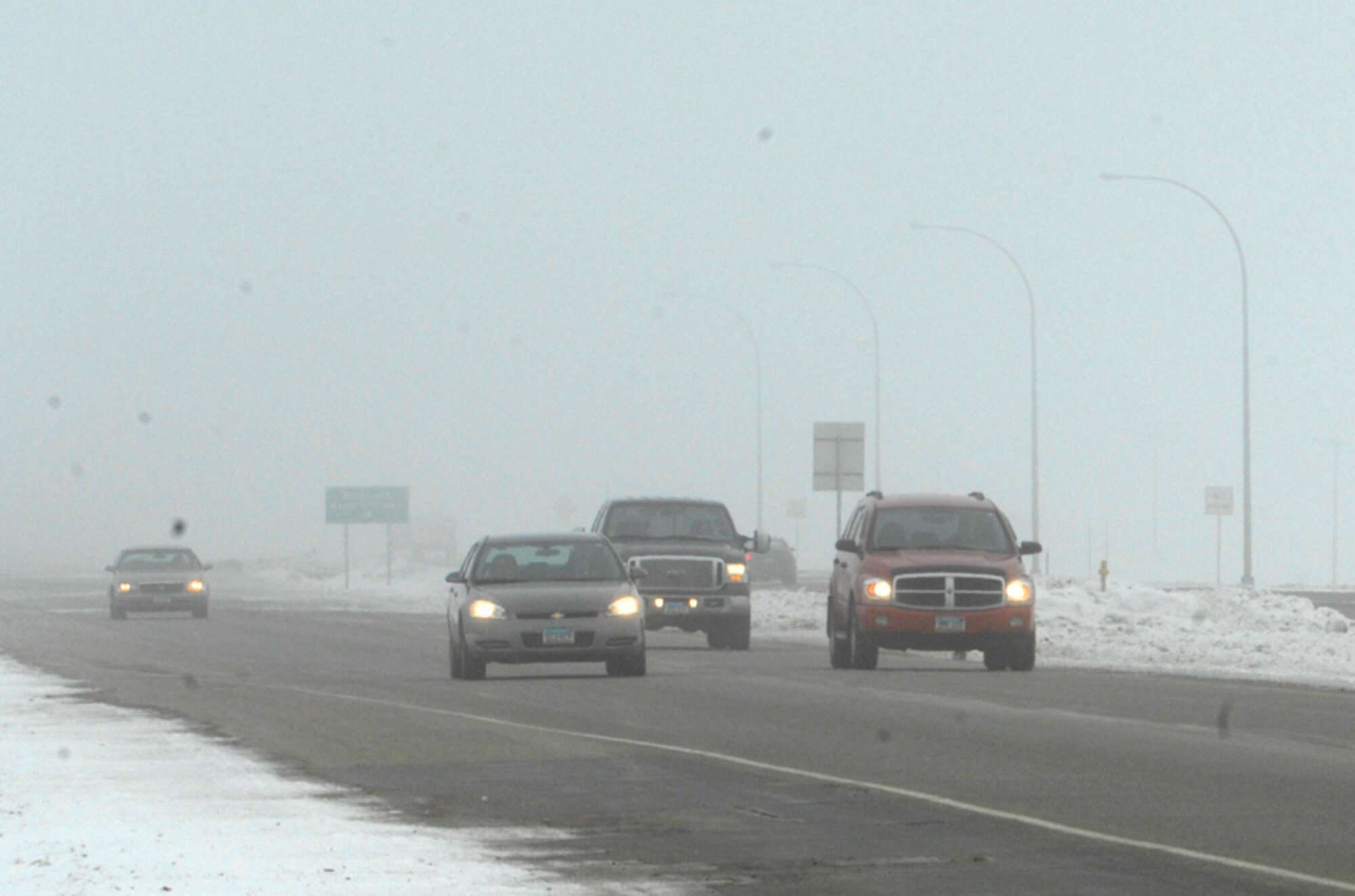 MINOT AIR FORCE BASE, N.D. -- Drivers travel through the fog on highway 83 Feb. 22. Thick fog is one of the many winter hazards all drivers should be aware and take caution. (U.S. Air Force photo by Airman 1st Class Ashley N. Avecilla)
