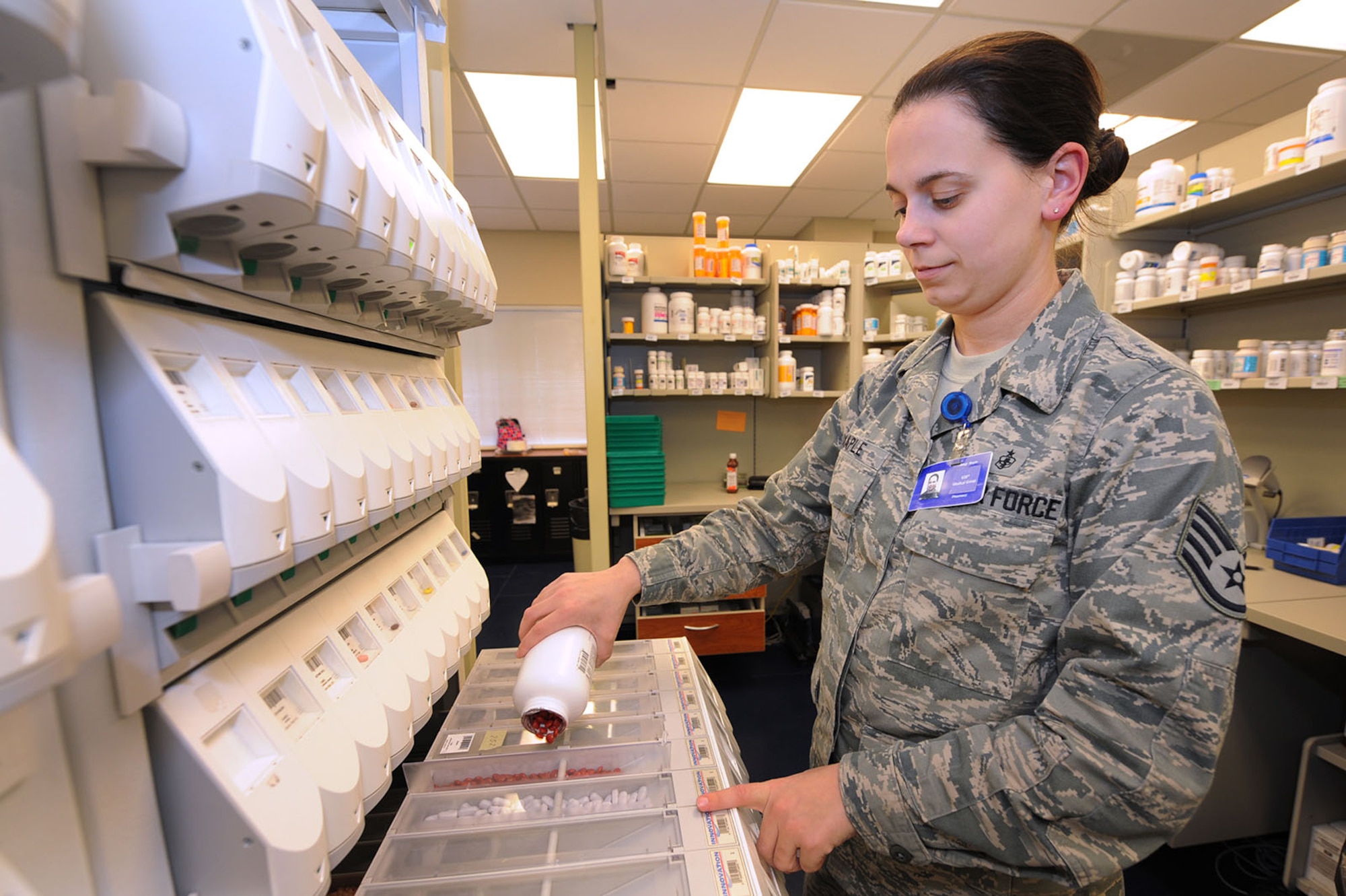 Staff Sgt. Josie Maple replenishes the pharmacists system with pills here Feb. 11.    In addition to provide pharmacy support, the 628th Medical Group provides many functional areas within such as medical logistics, laboratory, diagnostics and therapeutics, readiness training, resource management, TRICARE operations and patient administration. Sergeant Maple with the 628th MDG and is the NCO in charge of pharmacy services. (U.S. Air Force photo/James Bowman)
