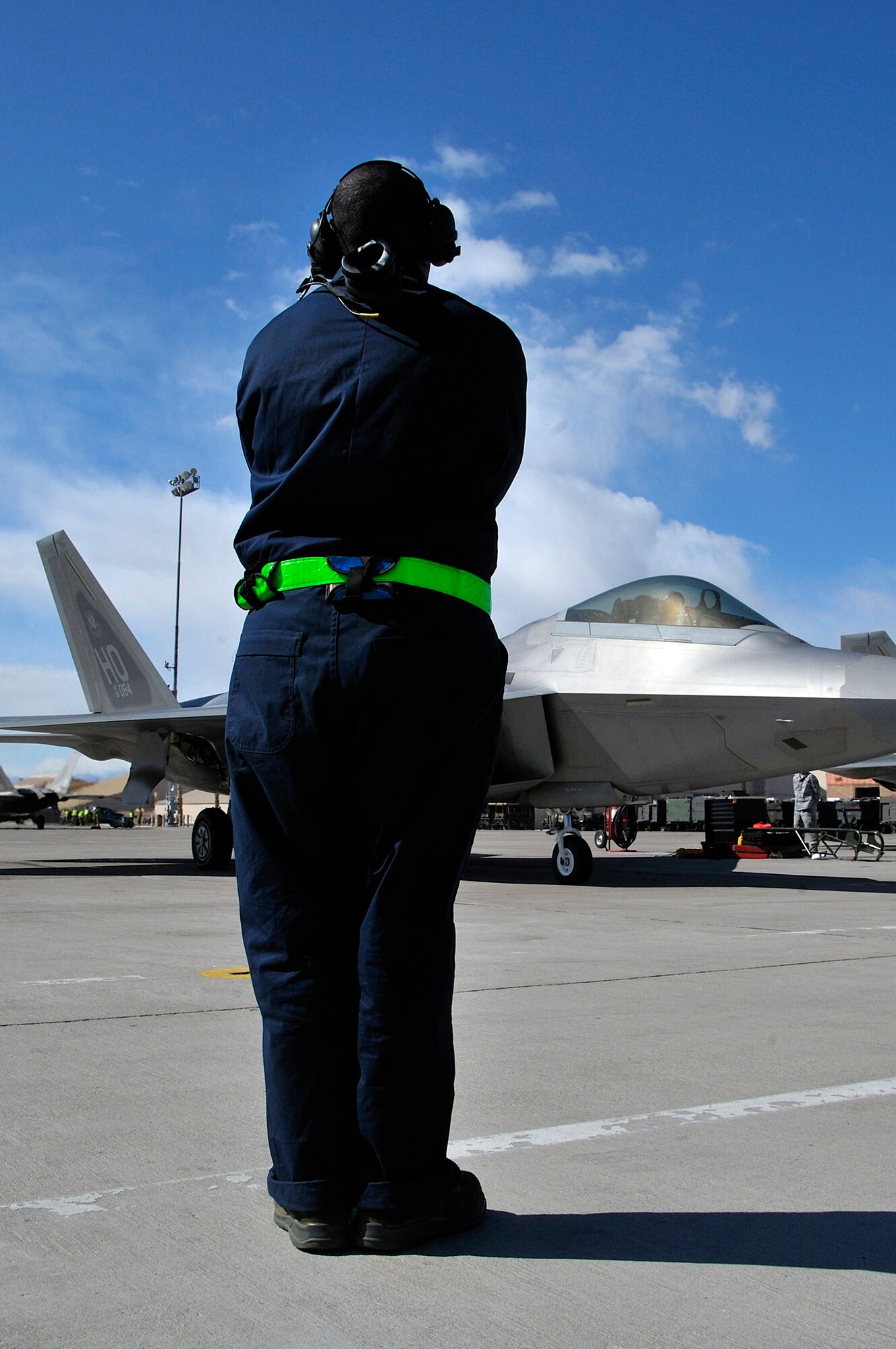 NELLIS AIR FORCE BASE, Nev. -- Senior Airman Arnee Pryor, a crew chief from the 49th Aircraft Maintenance Squadron at Holloman AFB, N.M., deployed to Nellis, prepares to launch an F-22 Raptor on opening day of Red Flag 10-3 Feb. 22. Airman Pryor has participated in Red Flag five times, yet is still excited and highly motivated for this flag. (U.S. Air Force photo by Tech. Sgt. Chris Flahive)