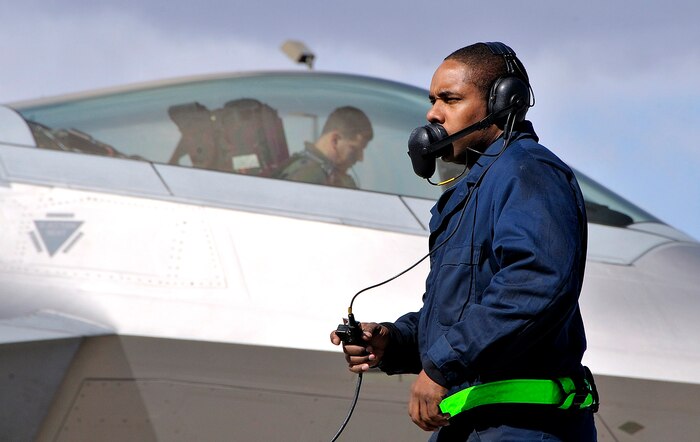 NELLIS AIR FORCE BASE, Nev. -- Senior Airman Arnee Pryor, a crew chief from the 49th Aircraft Maintenance Squadron at Holloman AFB, N.M., deployed to Nellis, prepares to launch an F-22 Raptor on opening day of Red Flag 10-3 Feb. 22. Airman Pryor has participated in Red Flag five times, yet is still excited and highly motivated for this flag. (U.S. Air Force photo by Tech. Sgt. Chris Flahive)
