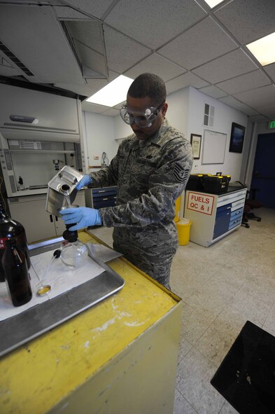 MINOT AIR FORCE BASE, N.D. – Tech. Sgt. Isaac Robinson, 5th Logistic Readiness Squadron fuel laboratory non-commissioned officer in charge, examines a fuel sample Feb. 18. The laboratory inspects and filters out foreign objects from fuel on a daily basis. These inspections are vital to ensure safe and successful missions on Minot AFB. (U.S. Air Force Photo by Staff Sgt. Stacy Moless)