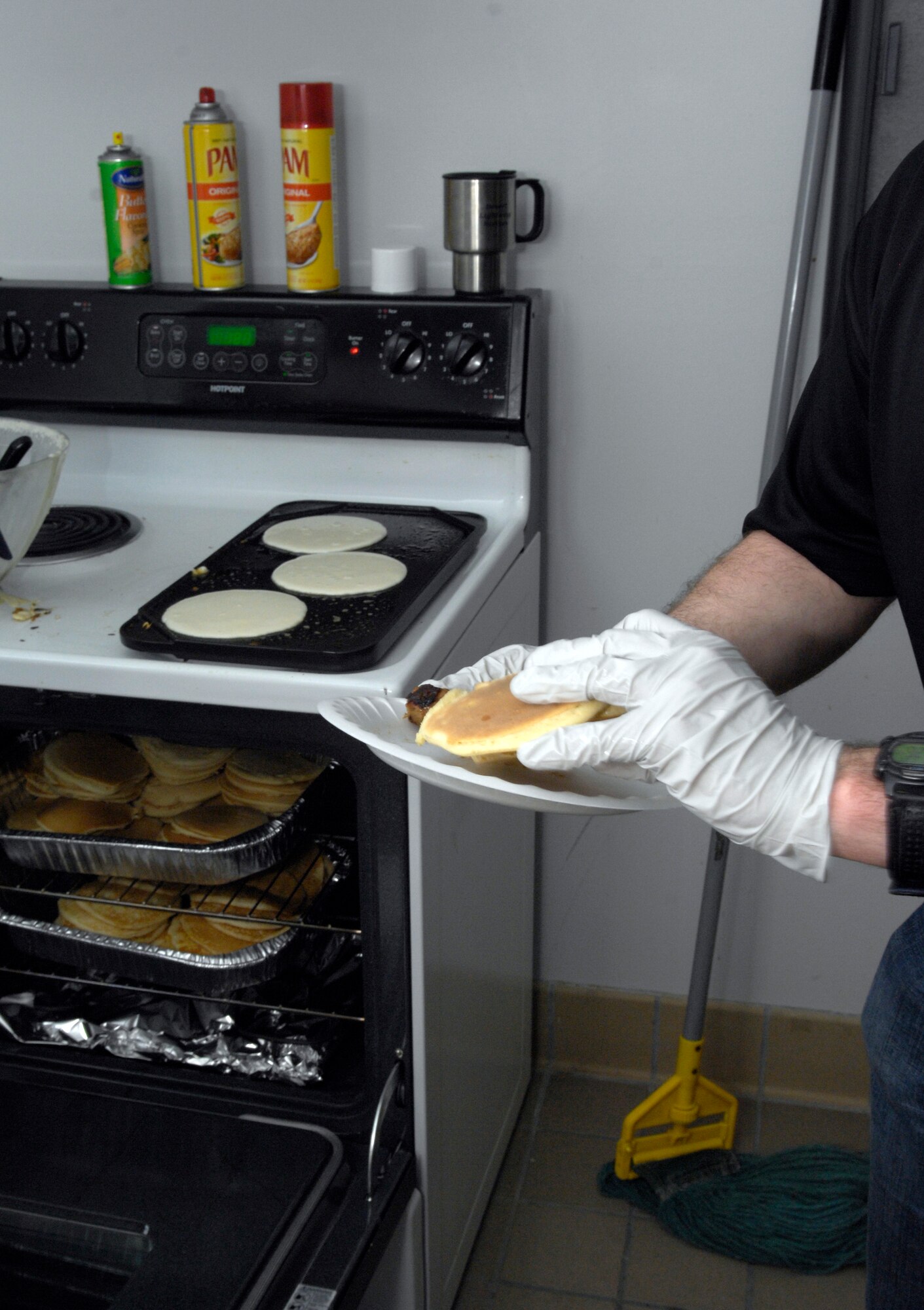 VANDENBERG AIR FORCE BASE, Calif. -- Piling on the flapjacks, Master Sgt. John Shade, first sergeant for the 533rd and 392nd Training Squadrons, serves breakfast during the First Sergeants' Pancake Breakfast hosted by the Airman and Family Readiness Center here Monday, Feb. 22, 2010. The breakfast was served during the Military Saves Week, which is a social marketing campaign to persuade Service Member's to build wealth through saving and debt reduction. (U.S. Air Force photo/Airman 1st Class Lael Huss)