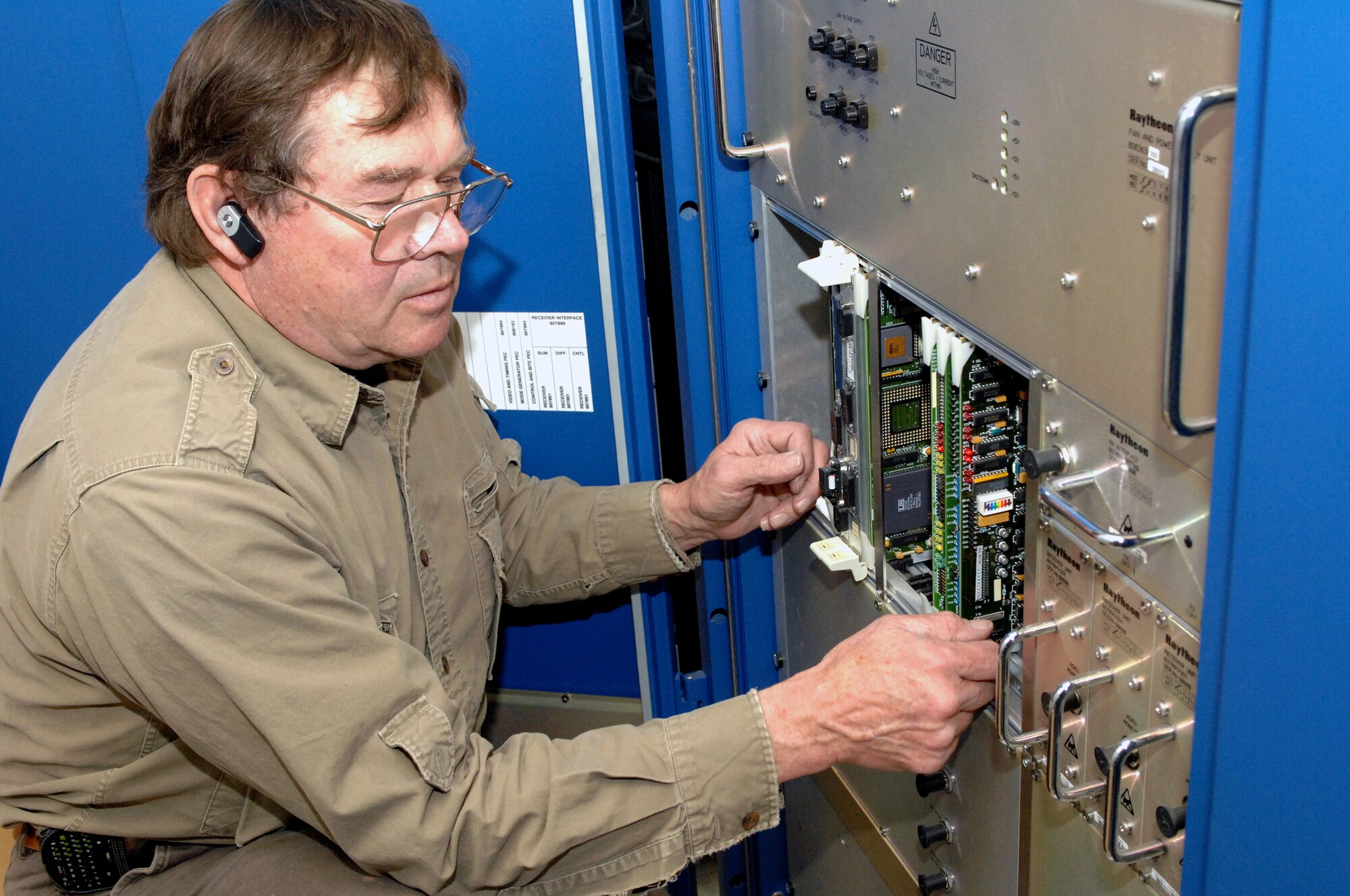 MINOT AIR FORCE BASE, N.D. – Bob Bradshaw, a contractor on Minot AFB, installs video and timing cards in the secondary radar in the traffic terminal area Feb. 18. The video and timing cards are used to support the secondary radar tower. These type of upgrades help improve overall base communications. (U.S. Air Force photo by Airman 1st Class Aaron-Forrest Wainwright)