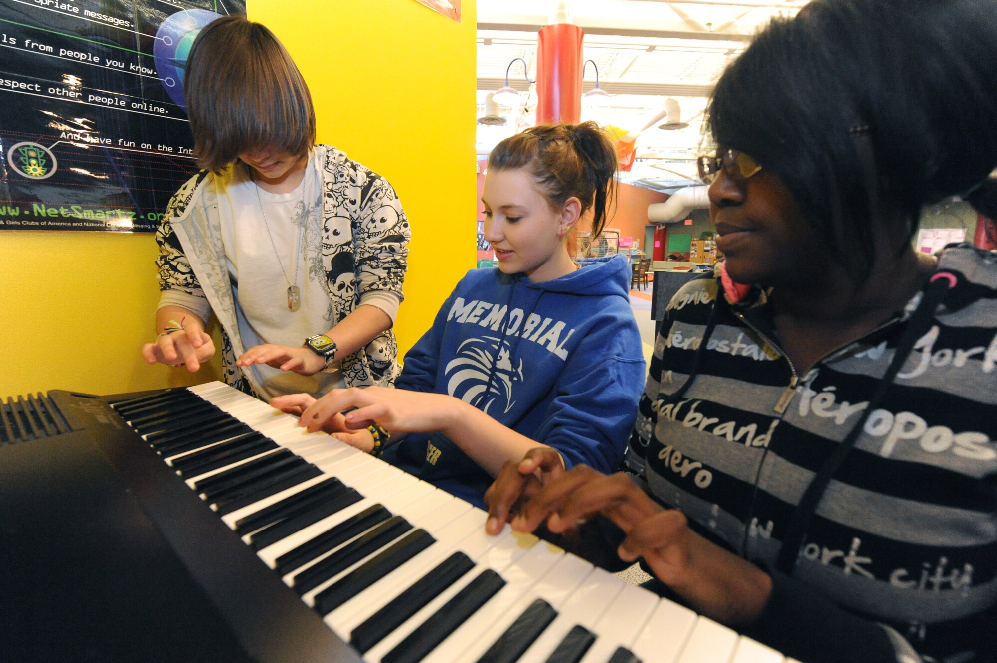 MINOT AIR FORCE BASE, N.D. – Memorial Middle School students, Kiya Jacobs, Katie Walkup and Tyler Moses, play piano at the David C. Jones Youth Center Feb. 18. The David C. Jones Youth Center is one of three highest-achieving centers involved in the Youth Employment Skills program and has been awarded the Air Force Services Youth Program of the Year numerous times. (U.S. Air Force Photo by Senior Airman Jesse Lopez)