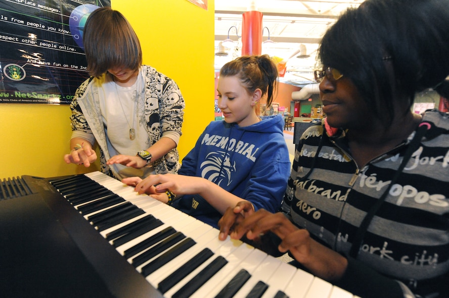 MINOT AIR FORCE BASE, N.D. – Memorial Middle School students, Kiya Jacobs, Katie Walkup and Tyler Moses, play piano at the David C. Jones Youth Center Feb. 18. The David C. Jones Youth Center is one of three highest-achieving centers involved in the Youth Employment Skills program and has been awarded the Air Force Services Youth Program of the Year numerous times. (U.S. Air Force Photo by Senior Airman Jesse Lopez)