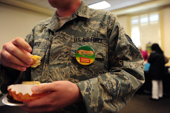 Staff Sgt. Kyle Lantz eats a hot dog during the Second Annual Force Support Squadron Food Show at the Charleston Club here Feb. 18. Individuals at the show tasted and voted on their favorite foods to be considered for addition to menus at various restaurants around base. (U.S. Air Force photo/Staff Sgt. Ali Flisek)