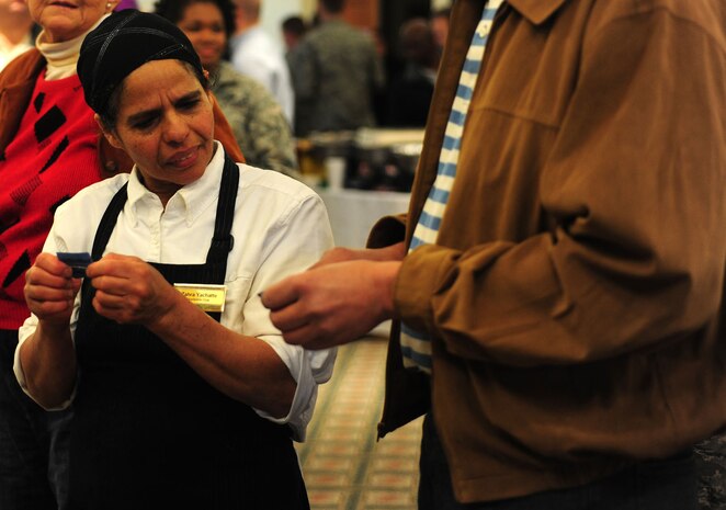 Zahra Yachatte helps check the numbers on attendees? raffle tickets for their chance to win prizes during the Second Annual Force Support Squadron Food Show at the Charleston Club here Feb. 18. Individuals at the show tasted and voted on their favorite foods to be considered for addition to menus at various restaurants around base. (U.S. Air Force photo/Staff Sgt. Ali Flisek)
