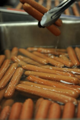 A vendor lifts franks out of a cooker at the Second Annual Force Support Squadron Food Show here Feb. 18. (U.S. Air Force photo/Senior Airman Daniel Owen)