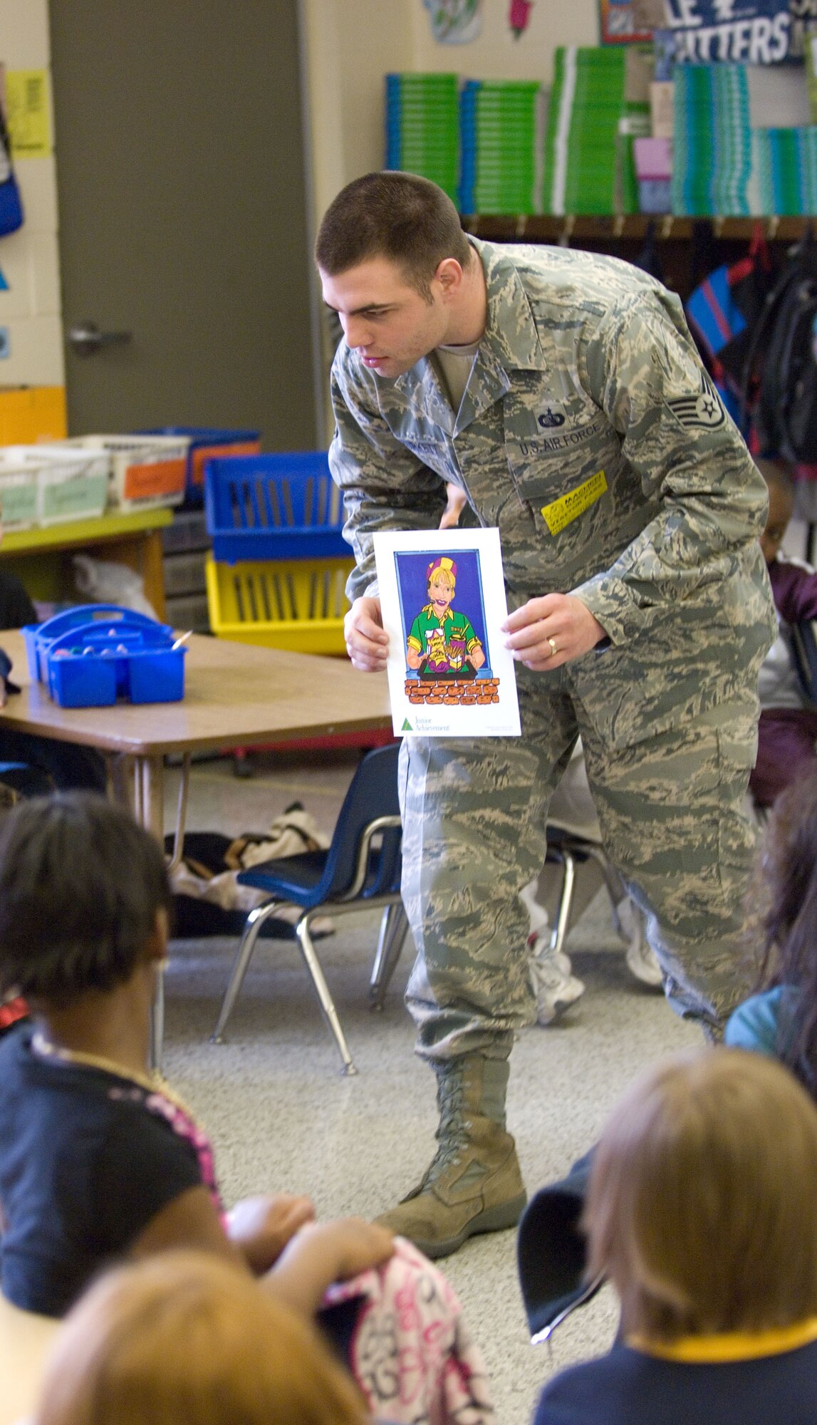 HAMPTON, Va. – Staff Sgt. Ryan Burkett, 83rd Communications Squadron Integrated Network Operations and Security Center Vulnerability Management technician, teaches students as part of a Junior Achievement program at Luther W. Machen Elementary School Feb. 23. Every week, Junior Achievement volunteers teach grade school students lessons in entrepreneurship, work readiness and financial literacy through hands-on programs.  (U.S. Air Force photo/Airman 1st Class Jason J. Brown)