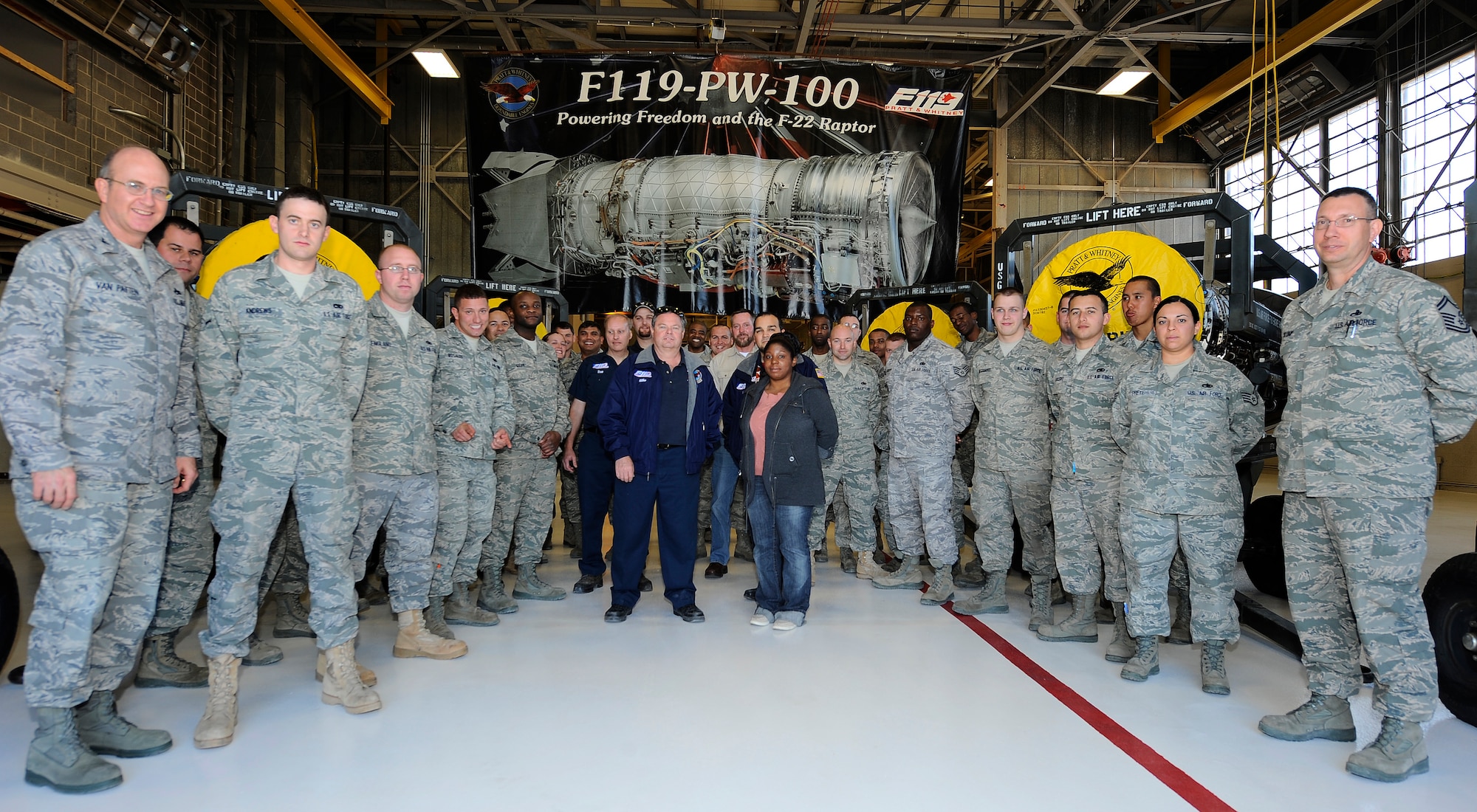 HOLLOMAN AIR FORCE BASE, N.M. -- Members from the 49th Maintenance Squadron pose for a group photo during the opening of the newly renovated engine shop, Feb. 12. The renovation, which totaled more than $2 million, included a new bridge crane, hoists, floor finish, wall paint, electrical panels and circuits, windows, eyewash stations, an air compressor, a hot water heater, refurbished bathrooms and offices and a relocated radiant heater. (U.S. Air Force photo by Airman 1st Class Veronica Stamps)