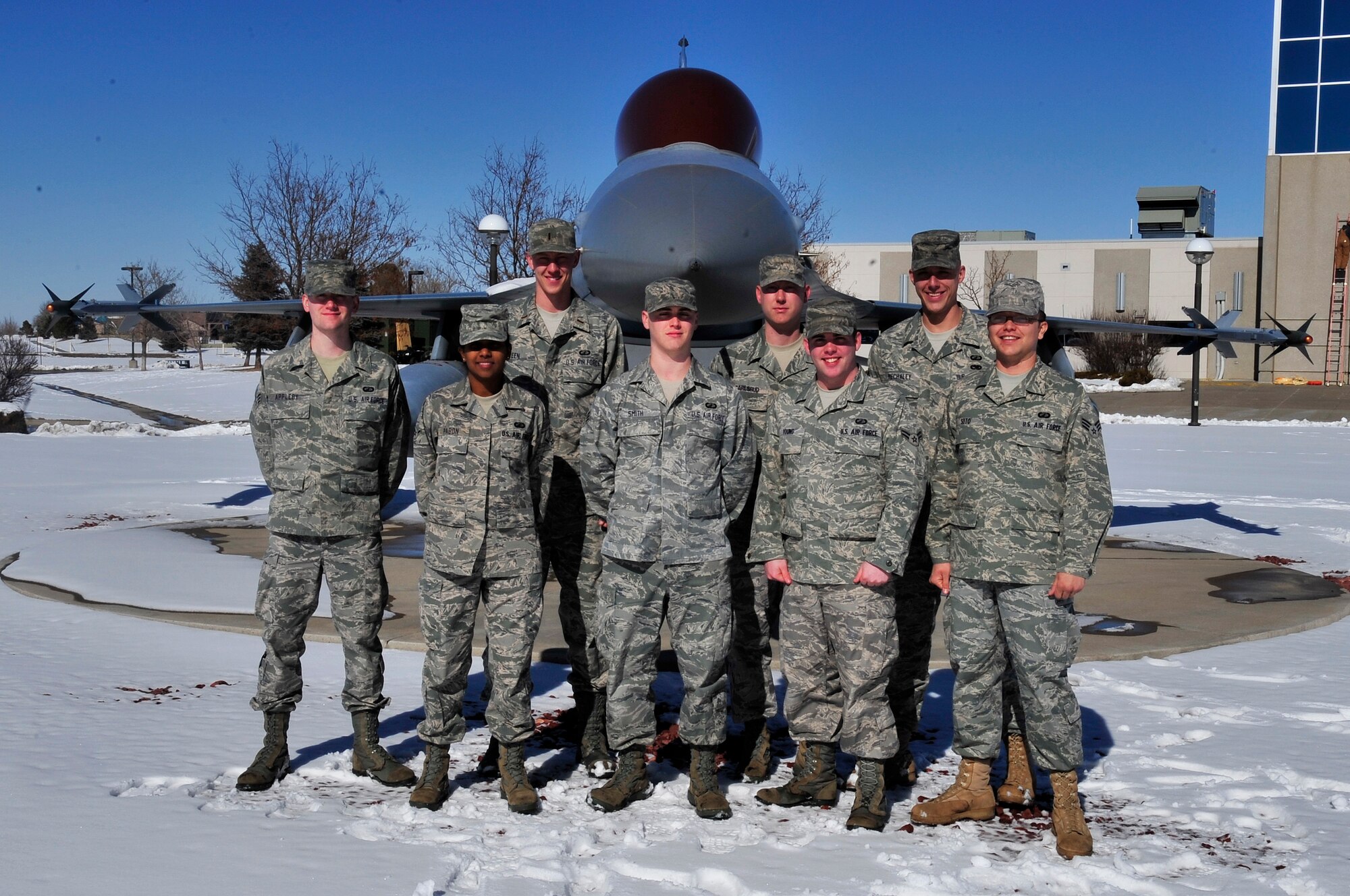 Buckley Air Force Base, Colo.-- The 460th Comptroller Squadron Financial Services Flight poses by an F-16 Fighting Falcon static display Feb. 23. (U.S. Air Force photo by Airman First Class Manisha Vasquez)