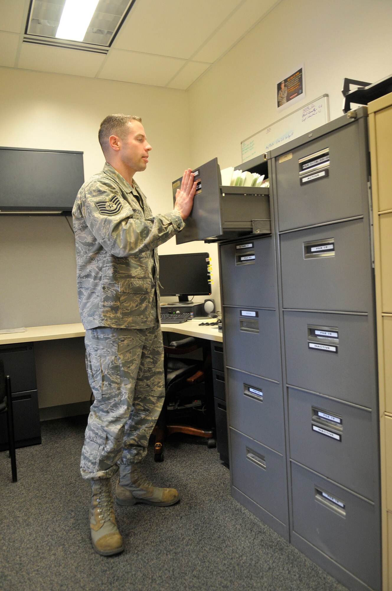 Tech. Sgt. Aaron Schroeder files a pilot's flight records into the cabinet Feb. 19, 2010, Eielson Air Force Base. The paper files are backed up by the electronic Aviation Resource Management System. Sergeant Schroeder is the 354th Operations Support Squadron flight records NCO in-charge. (U.S. Air Force photo/ Airman 1st Class Janine Thibault)