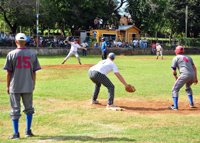 Players from both Soto Cano Air Base, Honduras and Utila stand poised to make a play as the pitcher throws the ball to the waiting batter Feb. 13 at the baseball field on Utila. The Soto Cano AB baseball team played against two Utila baseball teams Feb.13 and 14 to kick off Utila’s baseball season. (U.S. Air Force Photo/Staff Sgt. Bryan Franks) 
