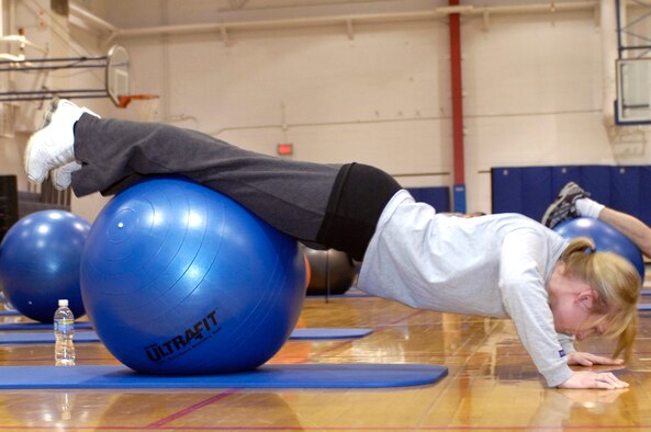 WHITEMAN AIR FORCE BASE, Mo. - Katie Dziedzic, 394th Combat Training Squadron, performs push-ups using an aerobic ball Feb. 16, 2010, during a P90X workout class now provided at the Whiteman Fitness Center. According to www.beachbody.com, P90X is a revolutionary system of 12 sweat-inducing, muscle-pumping workouts, designed to transform your body from regular to ripped in just 90 days. For more information, call the fitness center at 687-5496. (U.S. Air Force photo/Staff Sgt. Jason Barebo)