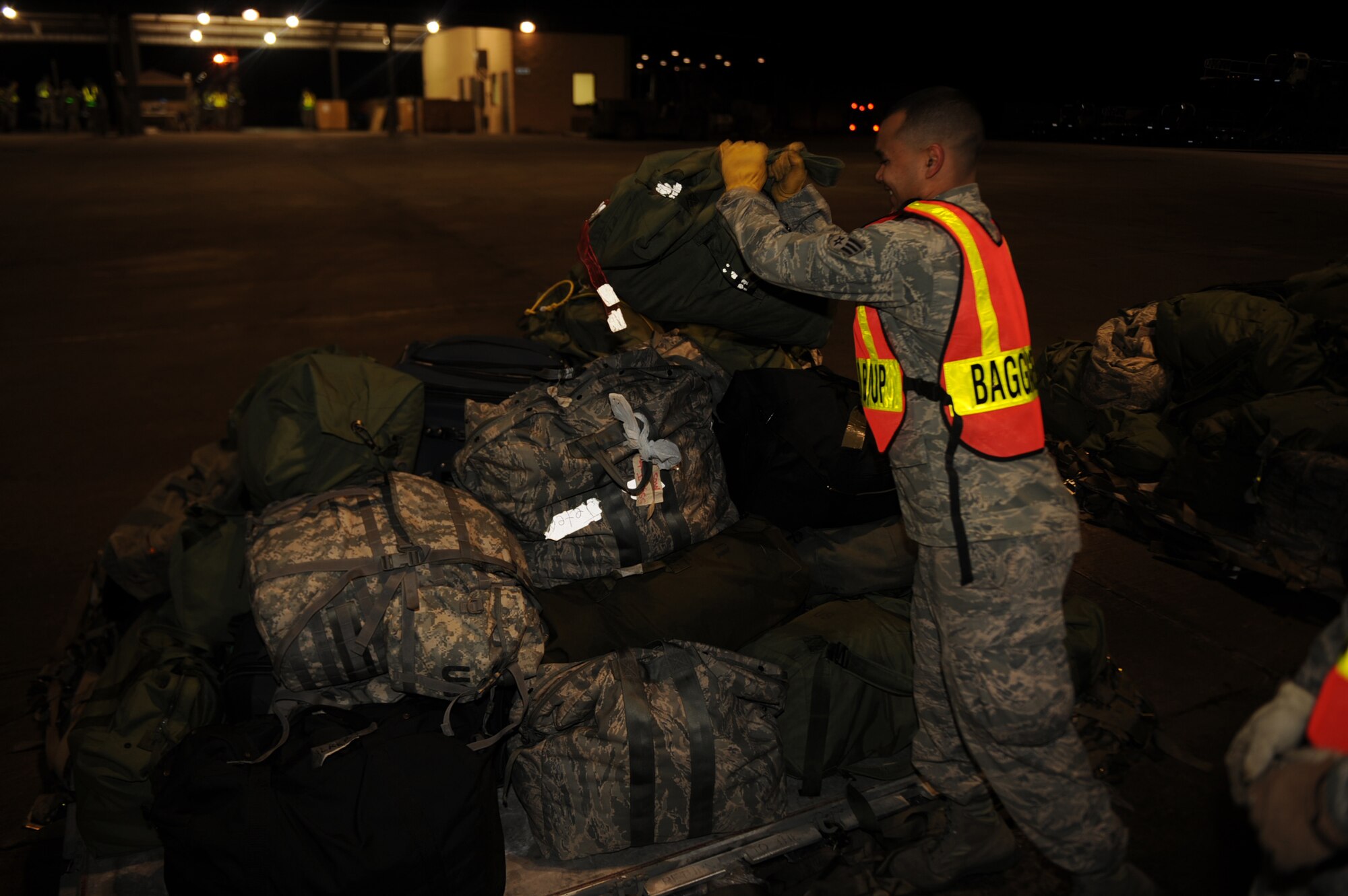 Senior Airman Rafael Rodriguez, 4th Communications Squadron client support administrator, loads baggage during a Phase I exercise on Seymour Johnson Air Force Base, N.C., Feb. 23, 2010. A Phase 1 exercise evaluates a unit's preparation and mobilization from peacetime readiness into wartime posture on short notice. Rodriguez hails from Brooklyn, N.Y. (U.S. Air Force photo/Senior Airman Ciara Wymbs) 