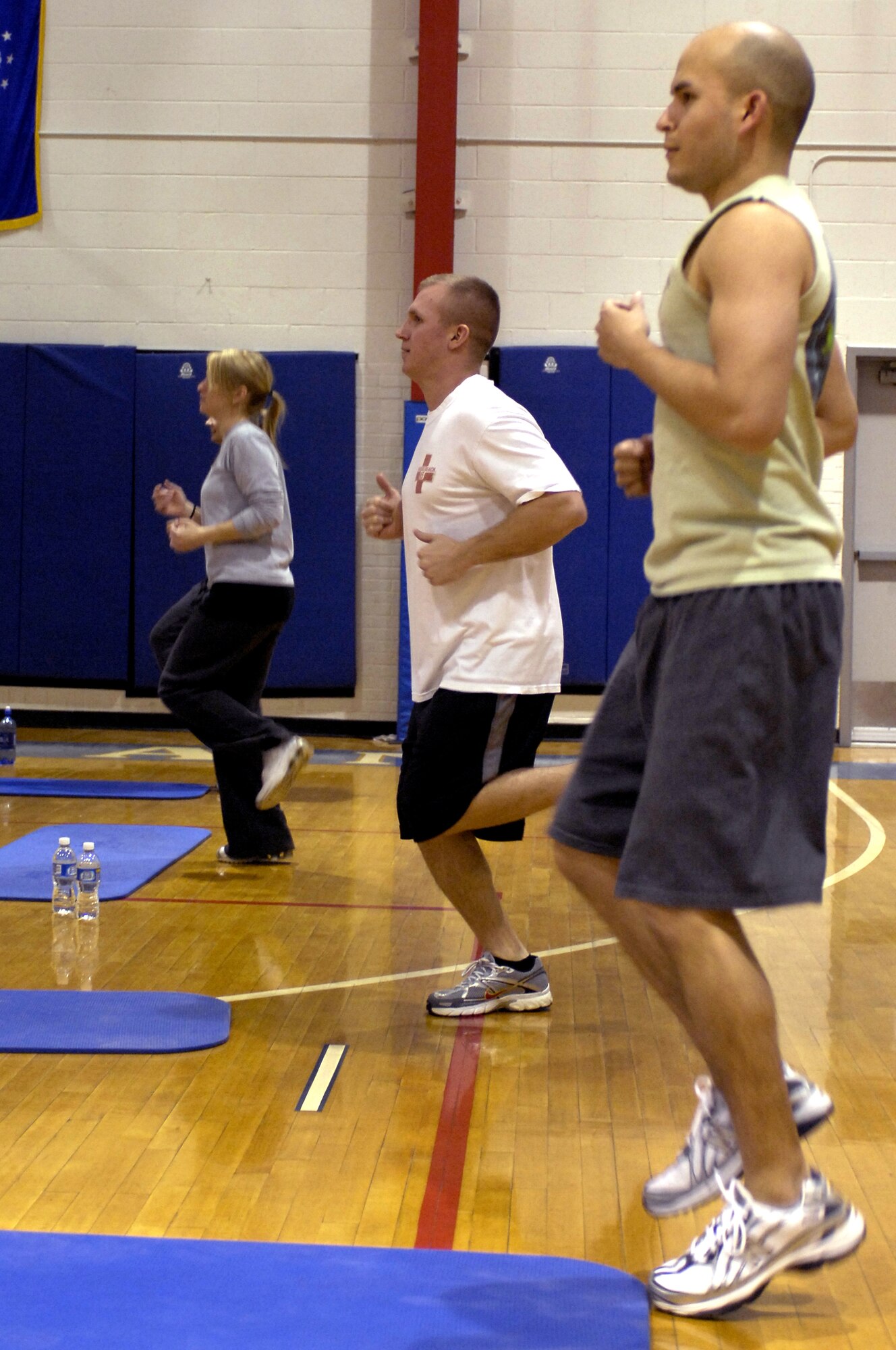 WHITEMAN AIR FORCE BASE, Mo. - Team Whiteman members run in place Feb. 16, 2010, during a P90X workout class now provided at the Whiteman Fitness Center. According to www.beachbody.com, P90X is a revolutionary system of 12 sweat-inducing, muscle-pumping workouts, designed to transform your body from regular to ripped in just 90 days. For more information, call the fitness center at 687-5496. (U.S. Air Force photo/Staff Sgt. Jason Barebo)