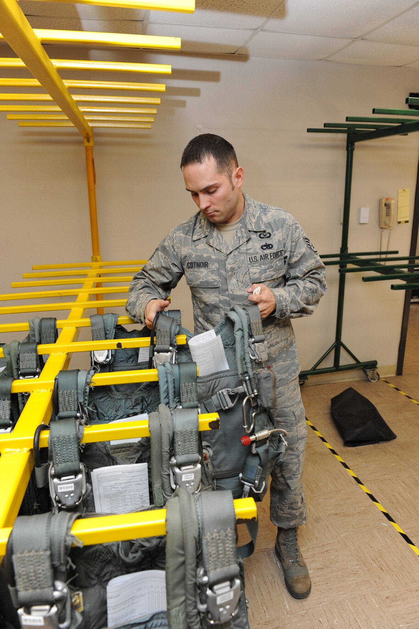 Staff Sgt Christopher Cotnoir, a 19th Operations Support Squadron member, retrieves a parachute backpack to inspect Feb. 18. Technicians inspect parachutes every 180 days to ensure they are within safety compliance standards. (U.S. Air Force photo by Senior Airman Ethan Morgan)