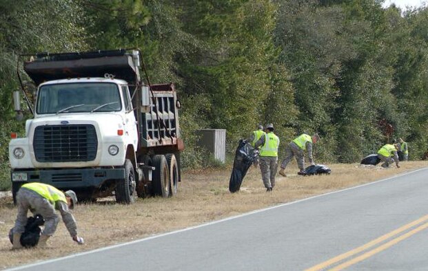 FORT WALTON BEACH, Fla. -- Volunteers from the 505th Command and Control Wing pick up trash along James Lee Road on  Feb. 19. Twenty volunteers filled trash bags with nearly 300 pounds of trash in a one hour, as part of the wing's participation in Adopt-a-County-Road program. (Photo by Keith Keel/U.S. Air Force)