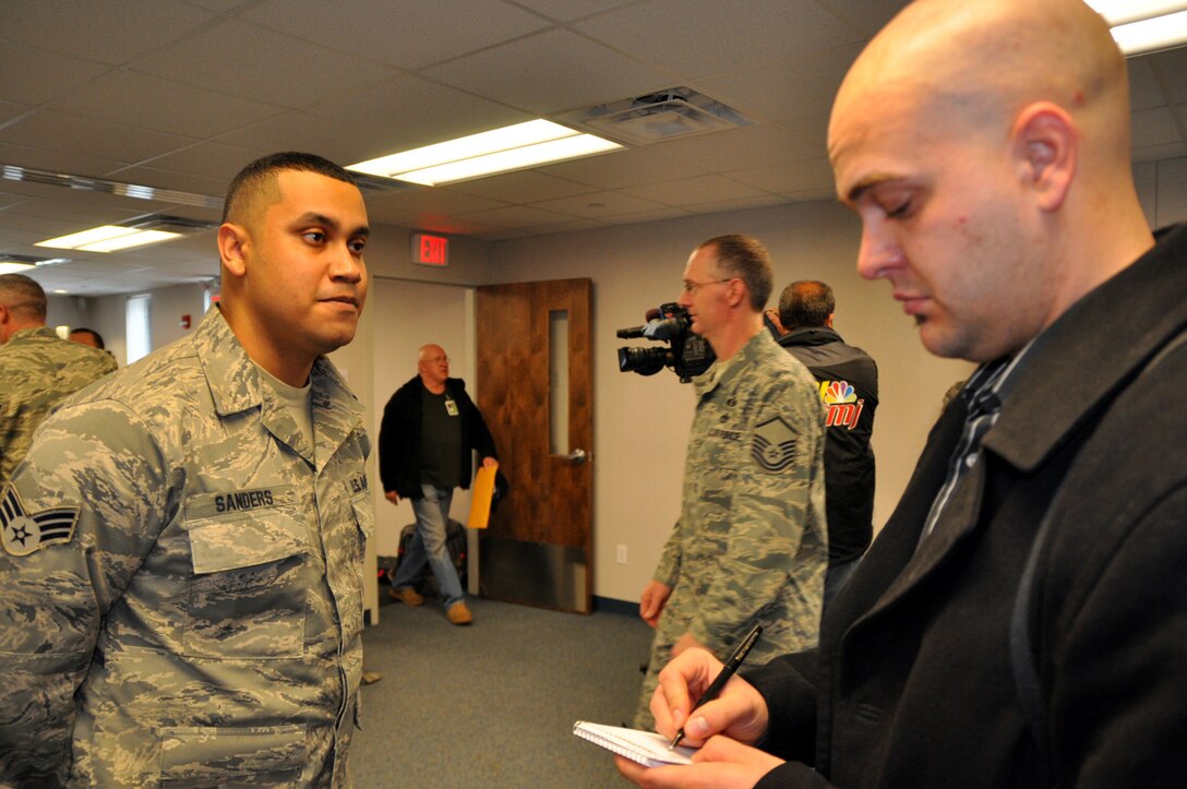 YOUNGSTOWN AIR RESERVE STATION, Ohio -- Air Force Reservist Senior Airman Mem D. Sanders, a civil engineer with the 910th Civil Engineer Squadron here, talks with a local news reporter Feb. 22, 2010, about his upcoming deployment to the Middle East.  Airman Sanders was among approximately 20 Citizen Airmen who departed YARS for a 6-month deployment to Kirkuk Air Base, Iraq, in support of Operation Iraqi Freedom. U.S. Air Force photo by Maj. Brent Davis