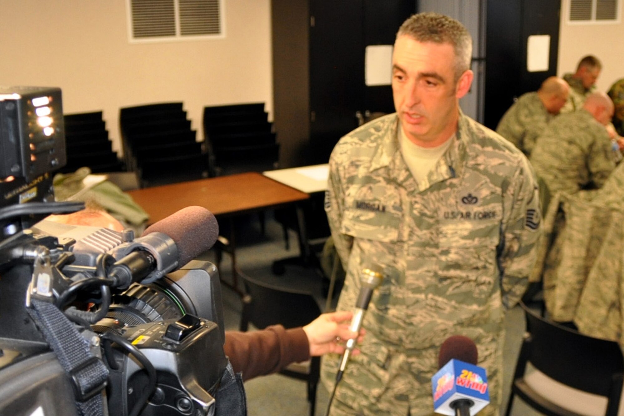YOUNGSTOWN AIR RESERVE STATION, Ohio -- Air Force Reservist Master Sgt. James Morgan, a civil engineer with the 910th Civil Engineer Squadron here, talks with local television news reporters Feb. 22, 2010, about his upcoming deployment to the Middle East.  Sergeant Morgan was among approximately 20 Citizen Airmen who departed YARS for a 6-month deployment to Kirkuk Air Base, Iraq, in support of Operation Iraqi Freedom. U.S. Air Force photo by Maj. Brent Davis