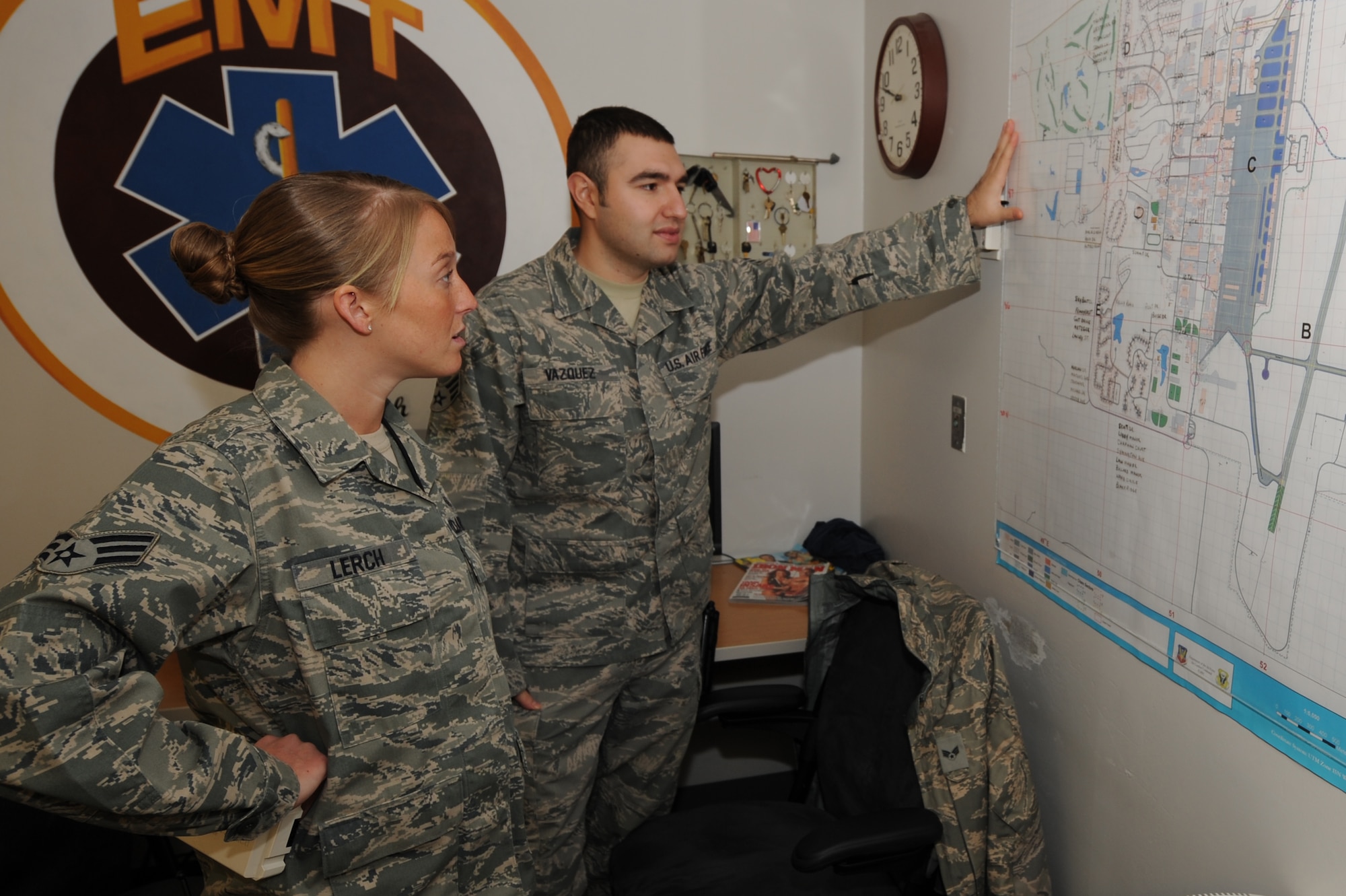 WHITEMAN AIR FORCE BASE, Mo. - Senior Airmen Melissa Lerch and Juan Vazquez, 509th Medical Operations Squadron aerospace medical technicians, review a base map to ensure they know the exact location of buildings on base to provide quick response, Feb. 23, 2010. The Ambulance Services flight operates on a 24 hours on, 48 hours off shift, supplying services to emergency calls as needed on and off-base. (U.S. Air Force photo/ Airman 1st Class Carlin Leslie)
