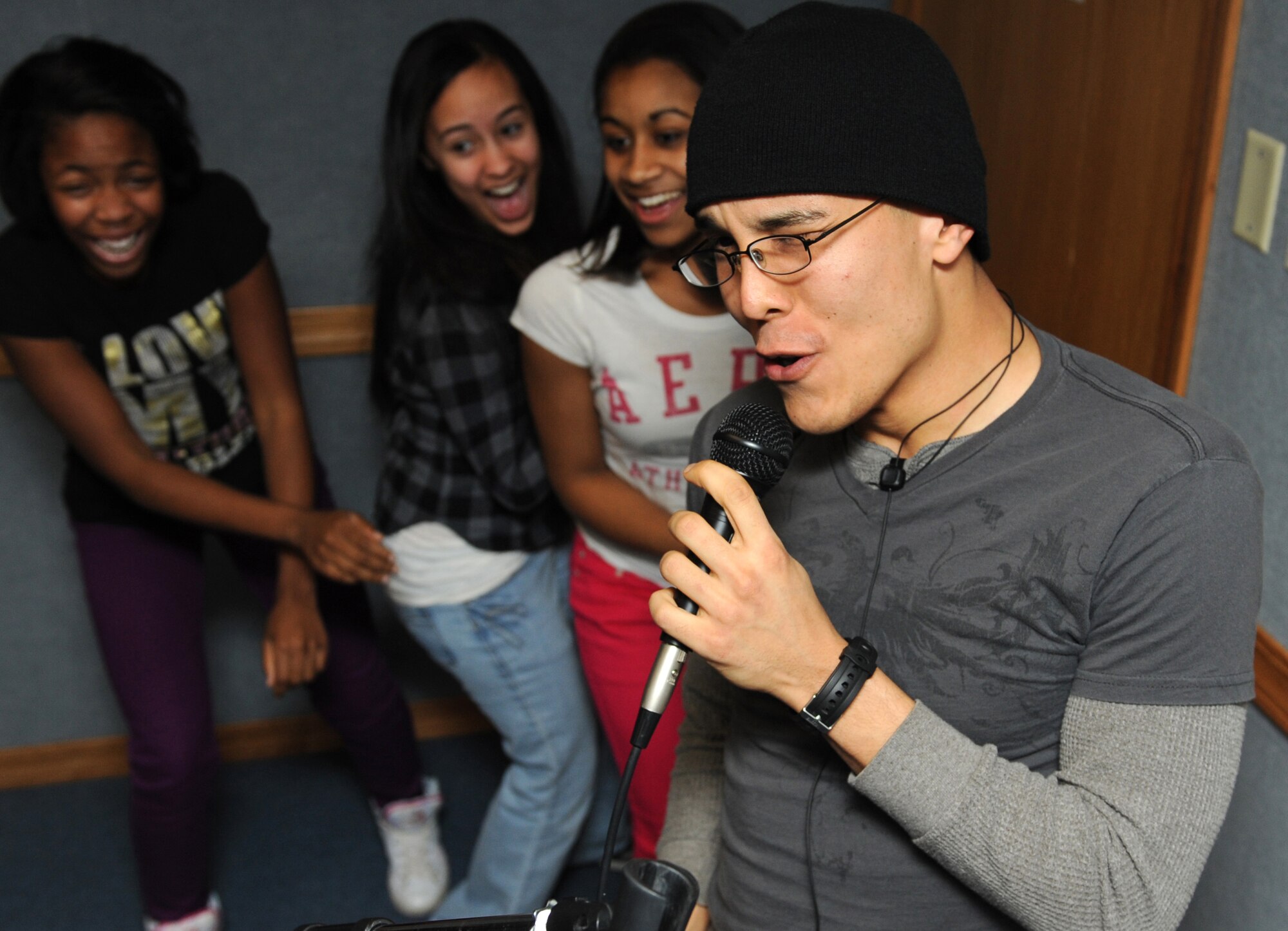 MOUNTAIN HOME AIR FORCE BASE, Idaho  --  Airman 1st Class Jason Irizarry, 366th Civil Engineer Squadron electrical apprentice, sings Karaoke during a pig roast held by Liberty Chapel Feb. 19. The pig roast was held to enhance moral for the Airmen living in the dorms and included free food, a live band, karaoke, and an Xbox tournament. (U.S. Air Force photo by Airman 1st Class Debbie Lockhart)