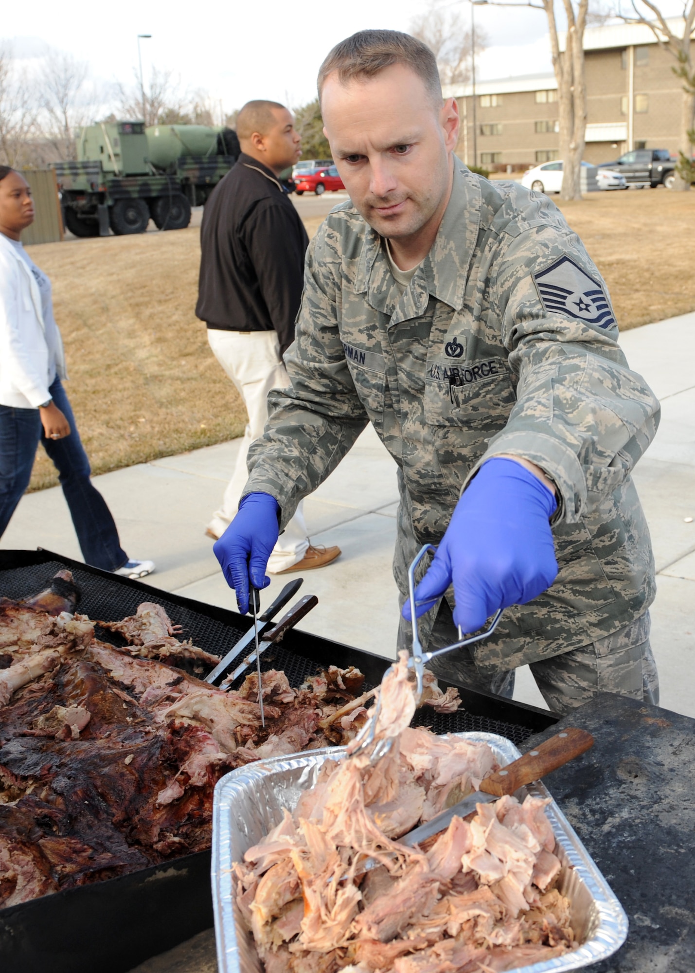 MOUNTAIN HOME AIR FORCE BASE, Idaho -- Master Sgt. Dave Boerman, 366th Civil Engineer Squadron non commissioned officer in charge of technical support, carves the pig at a pig roast held by Liberty Chapel Feb. 19. The pig roast was held by the base chapel to enhance moral for the Airmen living in the dorms and included free food, a live band, karaoke and an Xbox tournament. (U.S. Air Force photo by Airman 1st Class Debbie Lockhart)