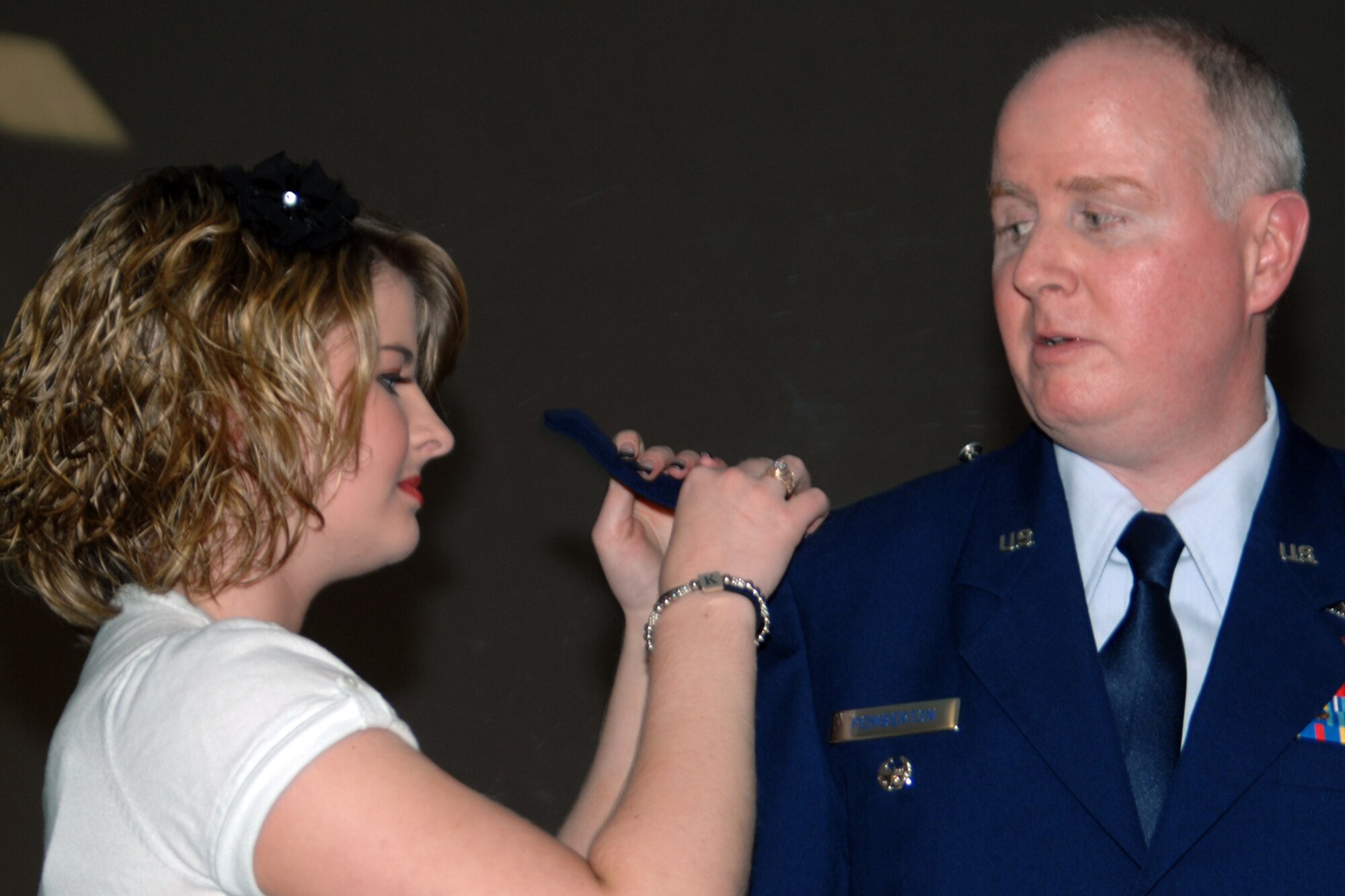 GRISSOM AIR RESERVE BASE, Ind. , -- Katherine Pemberton, daughter of Col. Thom Pemberton,  434th Operations Group, places an eagle insignia on her father's epaulet during a promotion ceremony.   (U.S. Air Force photo/Tech. Sgt. Doug Hays)