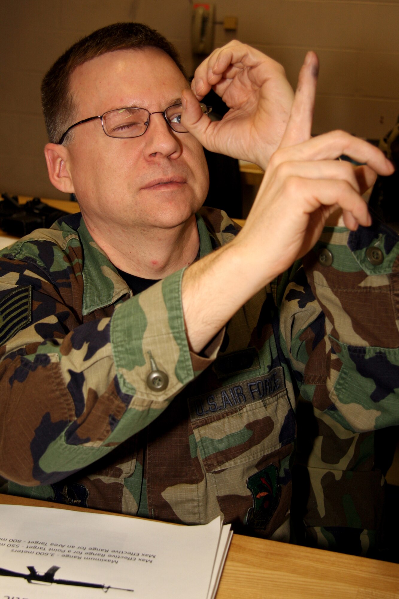 GRISSOM AIR RESERVE BASE, Ind. -- Tech. Sgt. Timothy Wooton, 434th Operations Support Squadron flight management specialist, uses his fingers to get the effect of looking down an M-16A2 iron site during a firearms refresher training course. (U.S. Air Force photo/Tech. Sgt. Mark. R. W. Orders-Woempner)