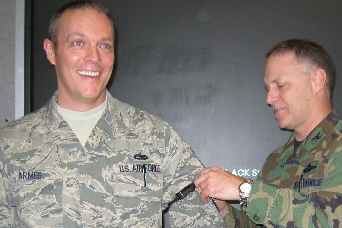 GRISSOM AIR RESERVE BASE, Ind., -- Johnny Armes, 434th Air Refueling Wing safety office, is all smiles as Col. Tim Cox, 434th ARW vice commander slides new master sergeant stripes onto his uniform. Sergeant Armes was recognized during a wing staff meeting. (U.S. Air Force photo/Senior Airman Carl Berry)