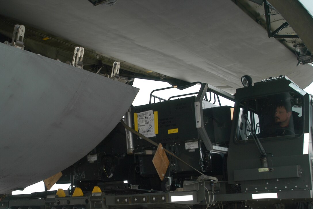 GRISSOM AIR RESERVE BASE, Ind., -- Fleet Witmeyer, a contractor with Data Monitor Systems, Inc., watches the direction of a load master as he maneuvers a k-loader into position under a C-5 Galaxy. Grissom held a cargo exercise here recently.  (U.S. Air Force photo/Staff Sgt. Chris Bolen)