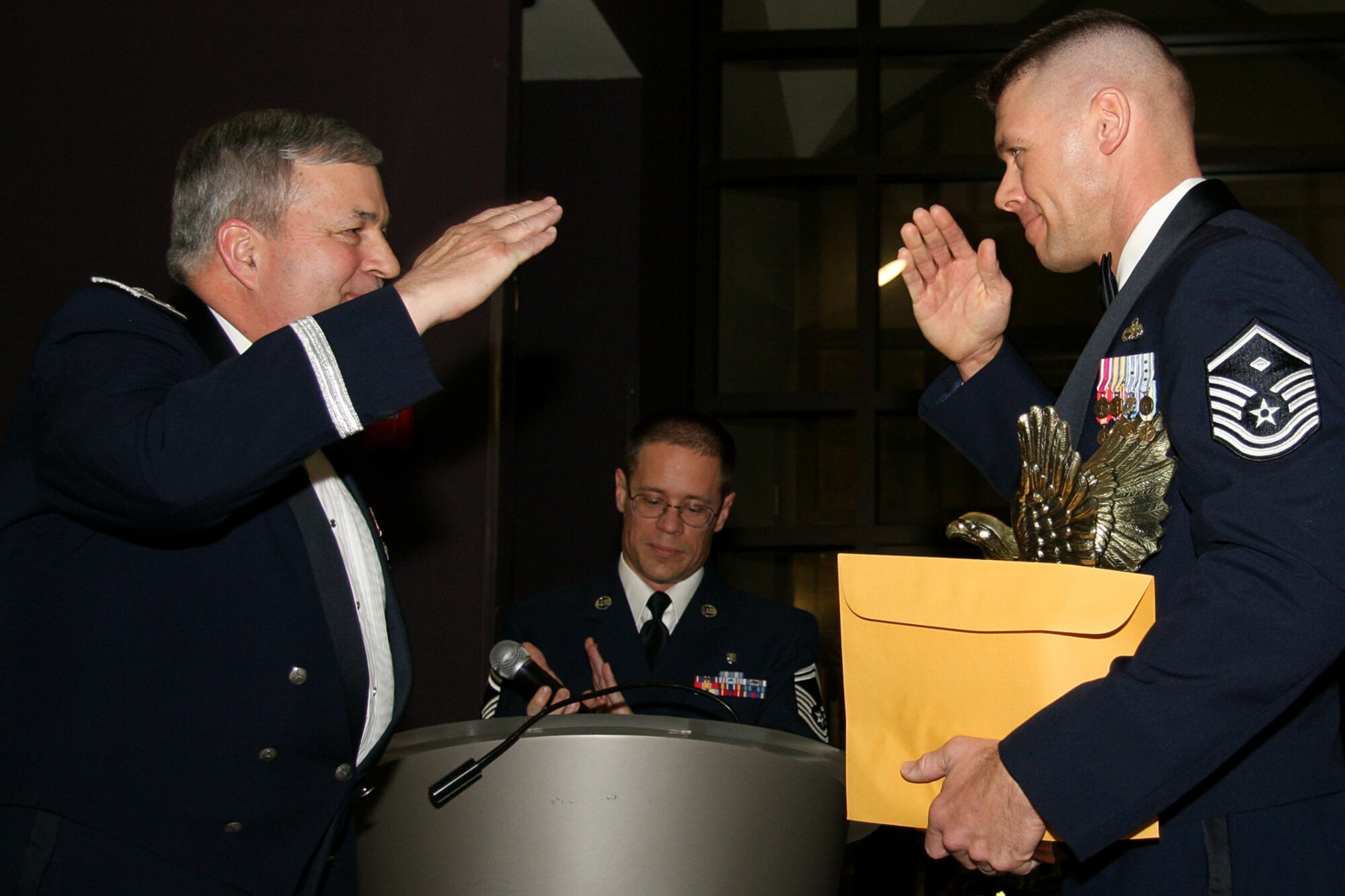 GRISSOM AIR RESERVE BASE, Ind. , -- Brig. Gen. Dean Despinoy, 434th Air Refueling Wing commander, left, returns the salute from Master Sgt. Paul Tomlinson 434th Services Flight first sergeant, after presenting him a trophy for being the First Sergeant of the  Year. (U.S. Air Force photo/Tech. Sgt. Mark Orders-Woempner)