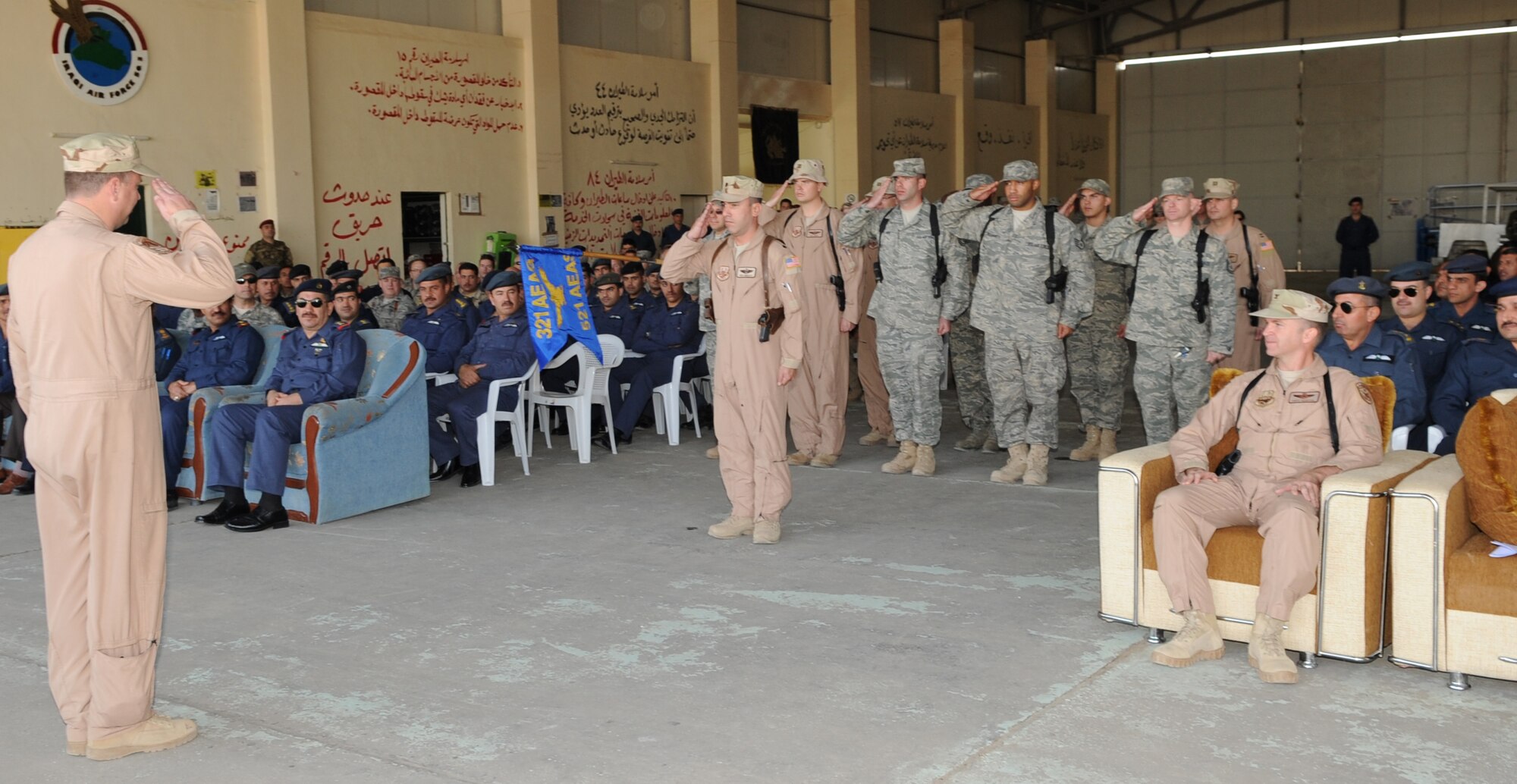 KIRKUK REGIONAL AIR BASE, Iraq – Lt. Col. Christopher Spigelmire, 521st Air Expeditionary Advisory Squadron commander, receives his last salute from the squadron before it’s decommissioning Jan. 11, 2010. Their mission was to train the Iraqi air force’s Squadron 3 to fly intelligence, surveillance and reconnaissance missions, and their mission is complete. (U.S. Air Force photo by Staff Sgt. Tabitha Kuykendall) 
