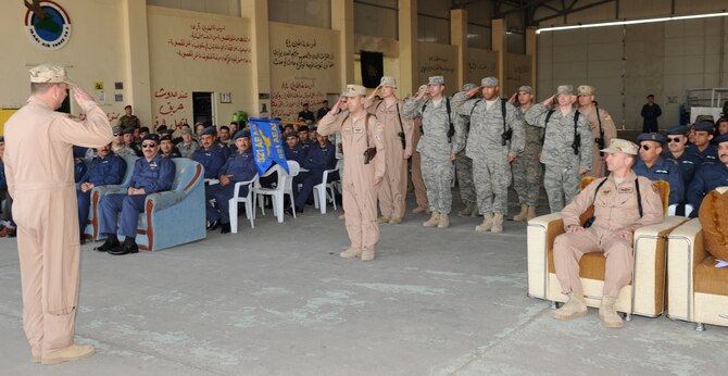 KIRKUK REGIONAL AIR BASE, Iraq – Lt. Col. Christopher Spigelmire, 521st Air Expeditionary Advisory Squadron commander, receives his last salute from the squadron before it’s decommissioning Jan. 11. Their mission was to train the Iraqi air force’s Squadron 3 to fly intelligence, surveillance and reconnaissance missions. (U.S. Air Force photo/Staff Sgt. Tabitha Kuykendall) 