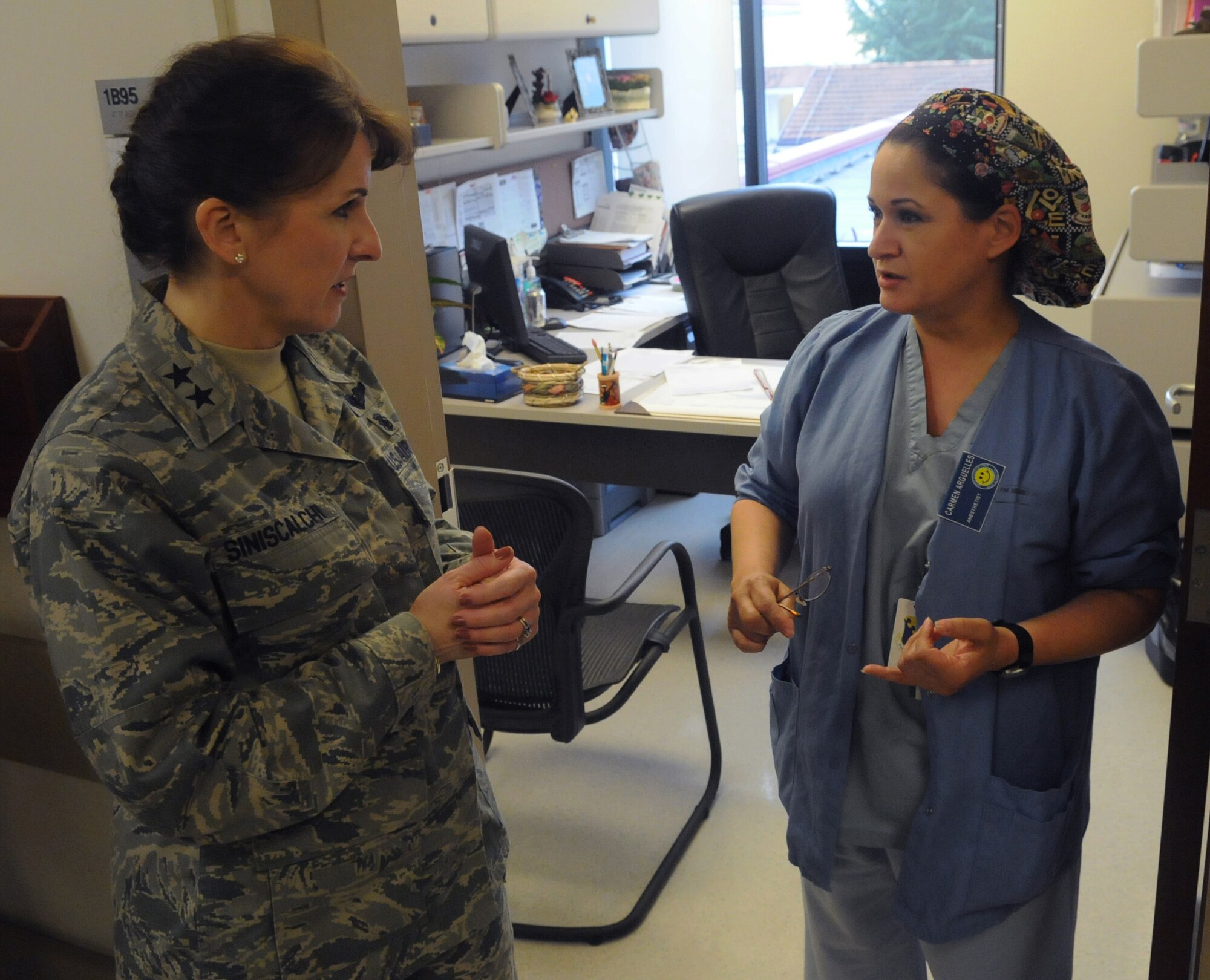 Maj. Carmen Arguelles, 31st Medical Group Anesthetist, talks with Maj. Gen. Kimberly A. Siniscalchi, Assistant Air Force Surgeon General, Medical Force Development, about her job at the Aviano Surgery section Feb. 22.While touring the Aviano medical clinic, General Siniscalchi was able to answer questions and build rapport with the Airman of the 31st Medical Group.(U.S. Air Force photo/Airman LaVel Sterling)