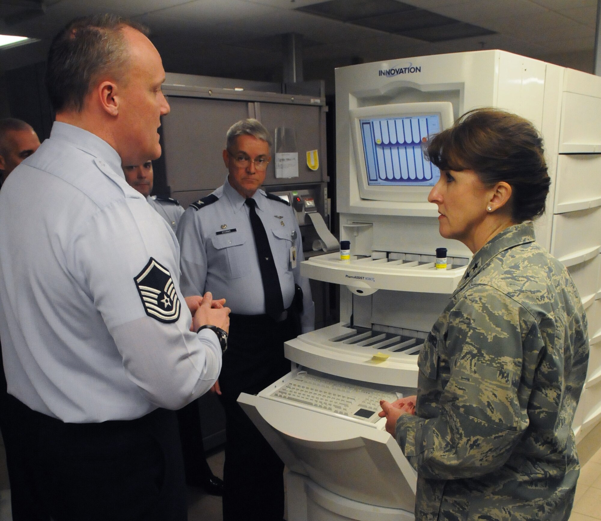 Master Sgt. Scotty Cass, 31st Medical Support Squadron, informs Maj. Gen. Kimberly Siniscalchi, Assistant Air Force Surgeon General, on how the pharmacy refill machine is operated Feb. 22. General Siniscalchi establishes new and appraises existing personnel policy and staffing requirements for 34,000 active-duty officer and enlisted medical personnel.(U.S. Air Force photo/Airman LaVel Sterling)