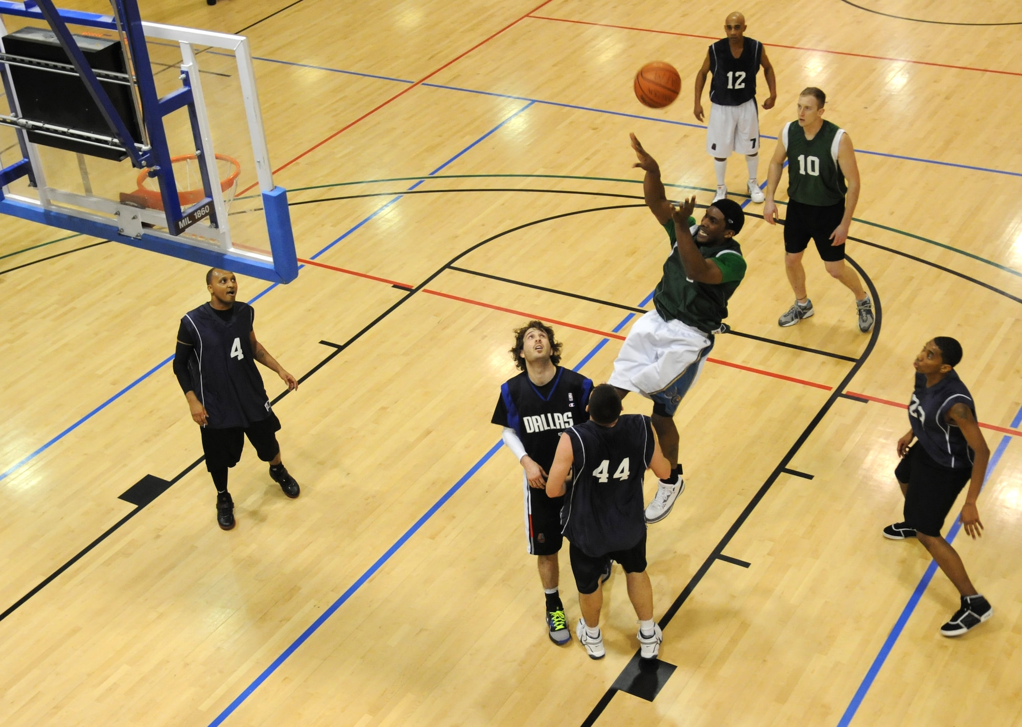 RAF MILDENHALL, England – Jonnie Story, 100th Maintenance Group, pulls up for a jump shot over Christopher Chiavuzzi and Daniel Porter, both with the 488th Intelligence Squadron, during the Intramural Basketball Championship game at the Hardstand Gym Feb. 18. Both teams battled for two 20 minute periods with MXG pulling off the upset over the IS 63-55, becoming RAF Mildenhall’s 2010 Intramural Basketball Champions. (U.S. Air Force photo/ Staff Sgt. Jerry Fleshman)