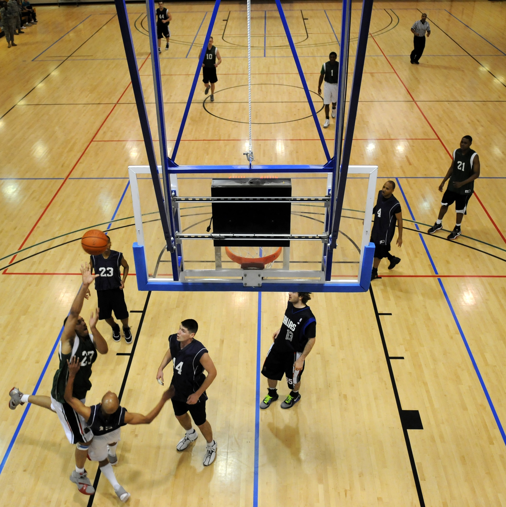 RAF MILDENHALL, England – Corey Fletcher, 100th Maintenance Group, attempts a shot after being fouled by Stacy Cochran, 488th Intelligence Squadron, after a fast break during the Intramural Basketball Championship game at the Hardstand Gym Feb. 18. (U.S. Air Force photo/ Staff Sgt. Jerry Fleshman)