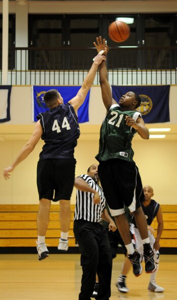 RAF MILDENHALL, England – John Wilson, 488th Intelligence Squadron, wins the tip off against Daniel Porter, 100th Maintenance Squadron, at the start of the Intramural Basketball Championship game at the Hardstand Gym Feb. 18. Both teams battled hard for two 20 minute periods with MXG finishing on top with the final score of 63-55, becoming RAF Mildenhall’s 2010 Intramural Basketball Champions. (U.S. Air Force photo/ Staff Sgt. Jerry Fleshman)