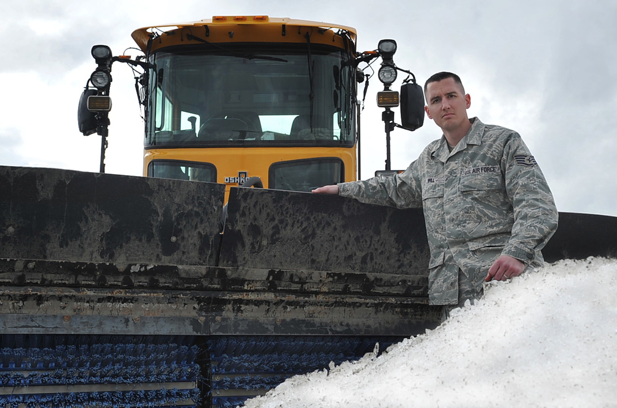 U.S. Air Force Staff Sgt. Adam Will, pavement and construction equipment journeyman, 786th Civil Engineer Squadron, poses for a photo on the flightline beside a snow sweeper, Ramstein Air Base, Germany, Feb. 22, 2010. Sergeant Will is one of the Airmen responsible for keeping the flightline clear of snow and debri. (U.S. Air Force photo by Senior Airman Tony R. Ritter)