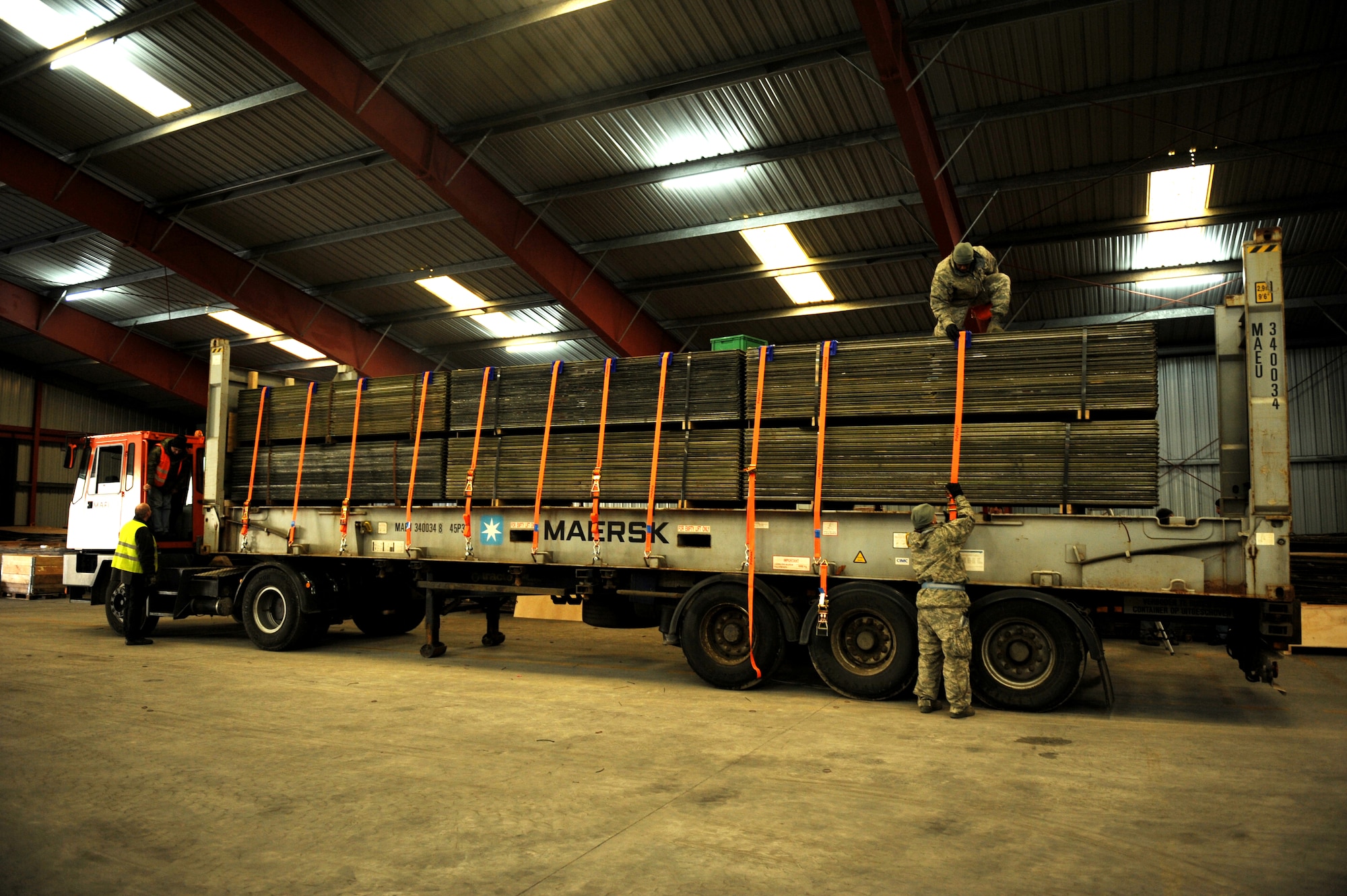 U.S. Air Force Tech. Sgt. Kimberly Blaum and Stevenson Johnson, both from the 86th Material Maintenance Squadron, Ramstein Air Base, Germany, prepares to strap down a AM-2 matt landing strip at the Central Region Storage Facility, Feb. 22, 2010, Sanem, District of Luxembourg, in support of ongoing war efforts. (U.S. Air Force photo by Tech. Sgt. Sarayuth Pinthong)