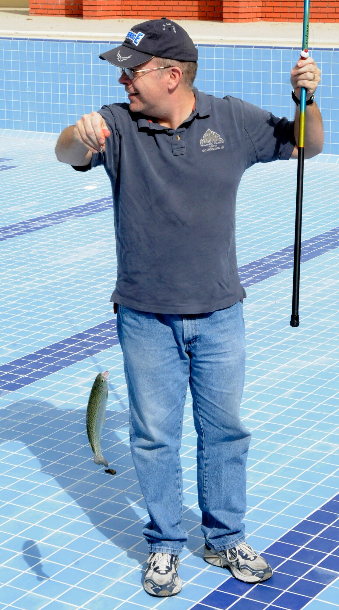 Lt. Col. Doug Houston, 39th Medical Group, shows off a catch Sunday, Feb. 21, 2010 during the Fishing Rodeo held by Outdoor Recreation at Incirlik Air Base, Turkey.  Outdoor Rec staff stocked the base pool with 400 trout and allowed Incirlik members to fish over the weekend between 9 a.m. and 3 p.m. The staff also supplied the fishing poles and bait and helped clean the fish for families to take home for dinner. (U.S. Air Force photo/Airman 1st Class Amber Ashcraft)