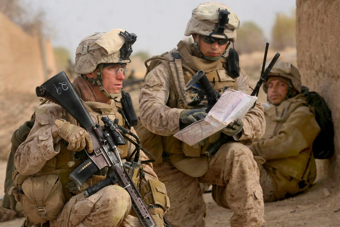 U.S. Marine Corps Staff Sgt. Ryan Clay, left, and Cpl. Anthony Deprimo, study a map while on a patrol in Marjah in Helmand province, Afghanistan, Feb. 21, 2010. Clay and Deprimo are assigned to India Company, 3rd Battalion, 6th Marine Regiment. The Marines and Afghan National army soldiers patrolled through a residential area of the city as part of Operation Moshtarak, a push to rid Marjah of Taliban presence and intimidation.