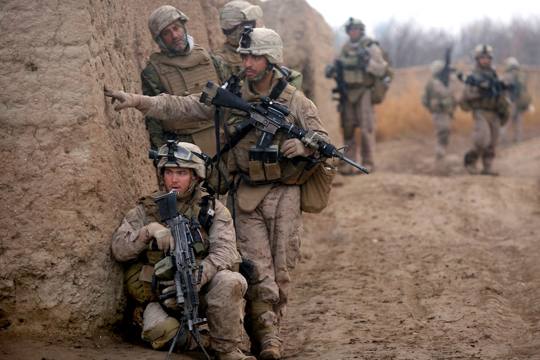 U.S. Marine Corps Lance Corporals Daniel Garner, kneeling, and Chris Ducharme investigate a possible improvised explosive device while on a patrol in Marjah in Helmand province, Afghanistan, Feb. 22, 2010. Garner and Ducharme are assigned to India Company, 3rd Battalion, 6th Marine Regiment. The Marines determined the suspected IED was nothing of concern.