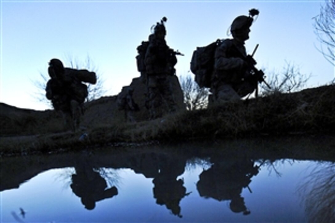 U.S. soldiers rest next to a canal during a patrol in Badula Qulp during Operation Helmand Spider in Helmand province, Afghanistan, Feb. 17, 2010. The soldiers are assigned to Company A, 1st Battalion, 17th Infantry Regiment.