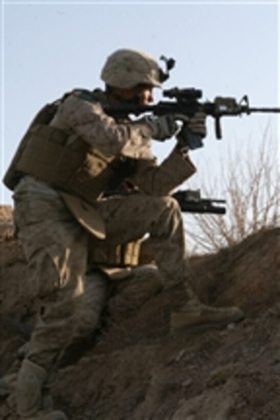 U.S. Marines with Bravo Company, 1st Battalion, 6th Marine Regiment take cover behind a berm after receiving accurate small-arms fire in the city of Marjah in Helmand province, Afghanistan, on Feb. 12, 2010.  Marines with Bravo Company, 1st Battalion, 6th Marine Regiment and Alpha Company, 1st Battalion, 6th Marine Regiment arrived in Marjah via helicopters as part of a large-scale offensive aimed at routing the Taliban from their last-known stronghold in Helmand.  