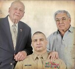 Larry Pinto, left, and Angelo Ciotta, stand over Sergeant Major Gary Buck, 1st Marine Corps District sergeant major. 1st MCD hosted a number of veterans from the battle of Iwo Jima including Pinto and Ciotta for an all-hands event with his Marines, Feb. 23, 2010. "The common bond we share is that we fought for our country. We embrace each other's willingness to serve," he said. (Official Marine Corps photo by Cpl. Clifton Sams, illistration by Sgt. Randall A. Clinton)