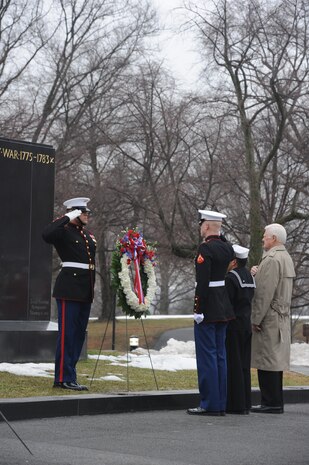 Cpl. Stephen Brewer, Lance Cpl. Thomas Mooney, Petty Officer 2nd Class Stephen Albright, and retired Lt. Col. Robert Lindholm, place a wreath in commemoration of the 65th anniversary of the flag raising on Iwo Jima.